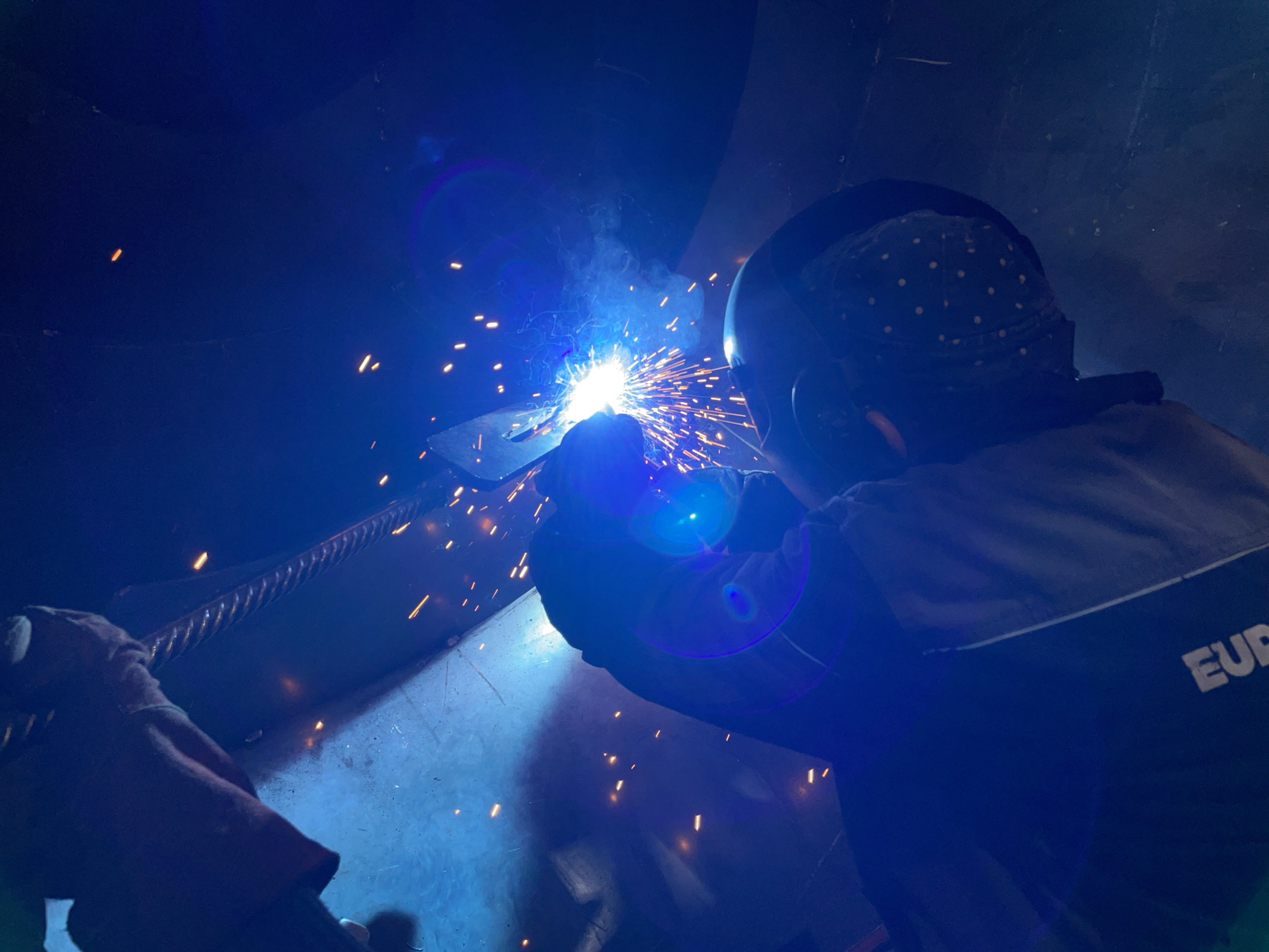Welder performs morning metalwork in Montenegro industrial workshop