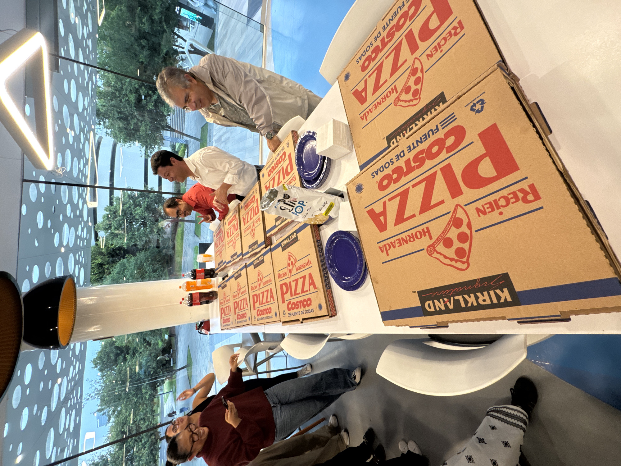 Office pizza gathering documented in Puebla, Mexico evening event