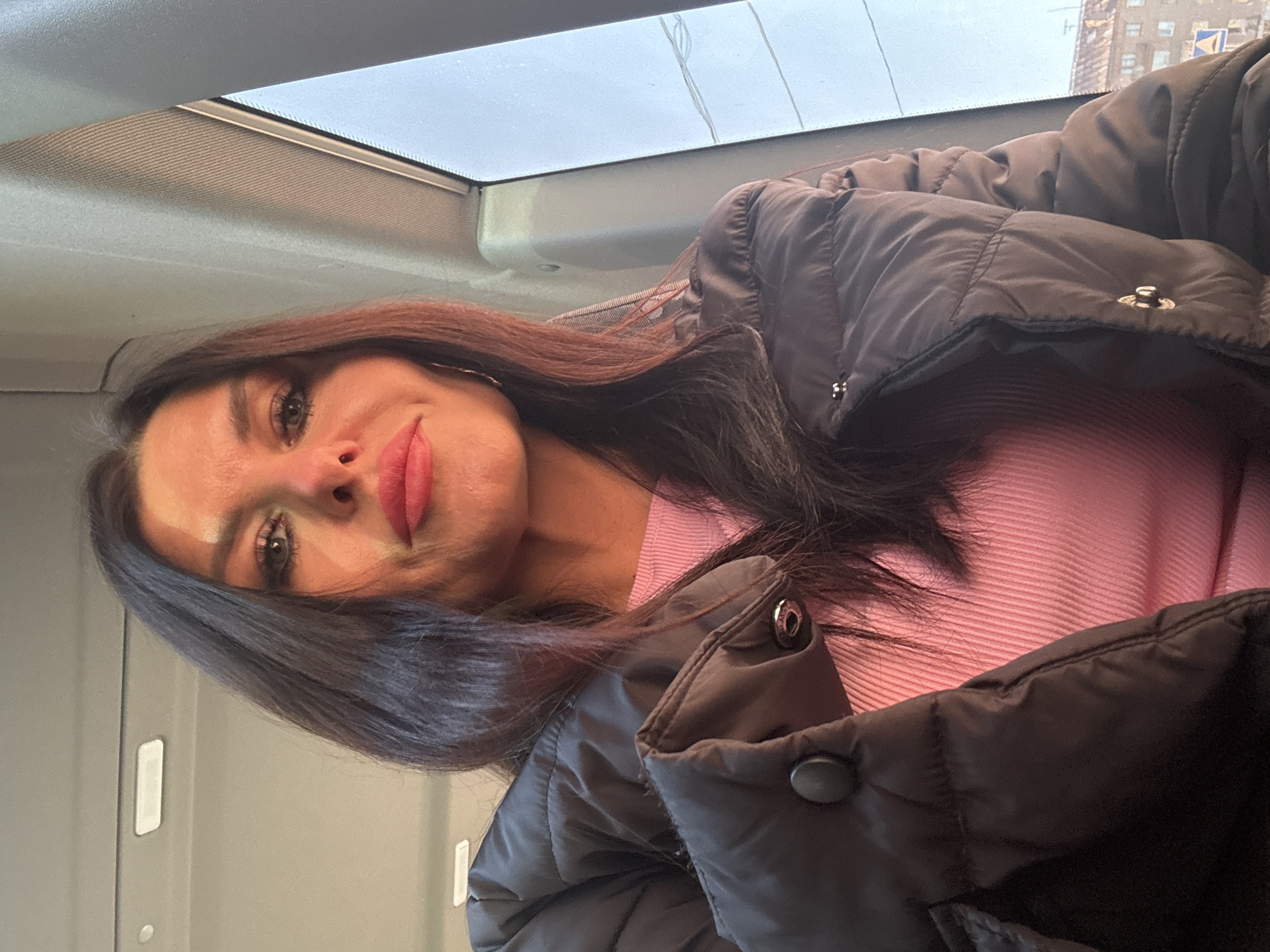 Woman in pink sweater observed inside vehicle in Gornozavodsk