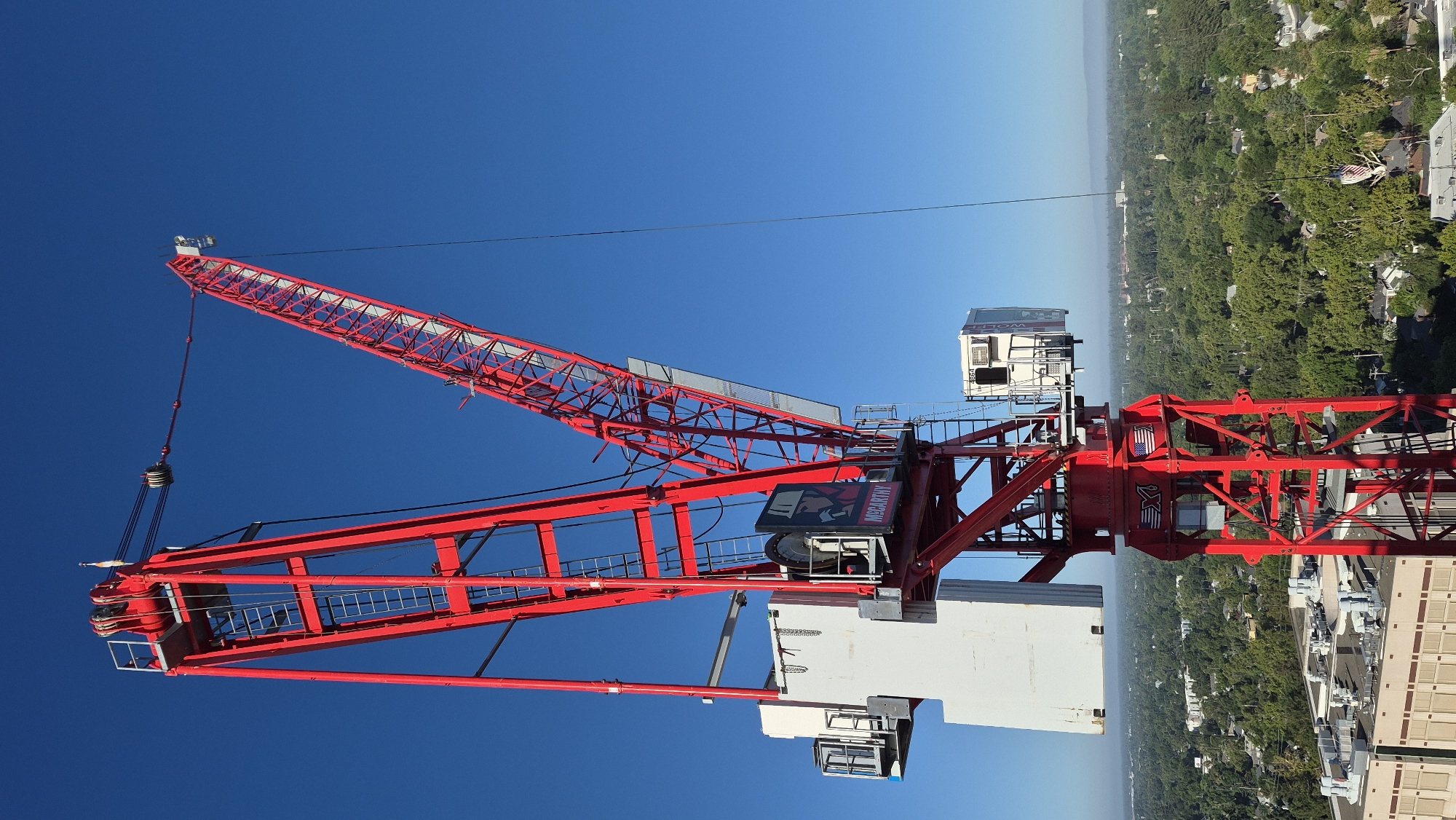 Red tower crane rises over Sacramento skyline