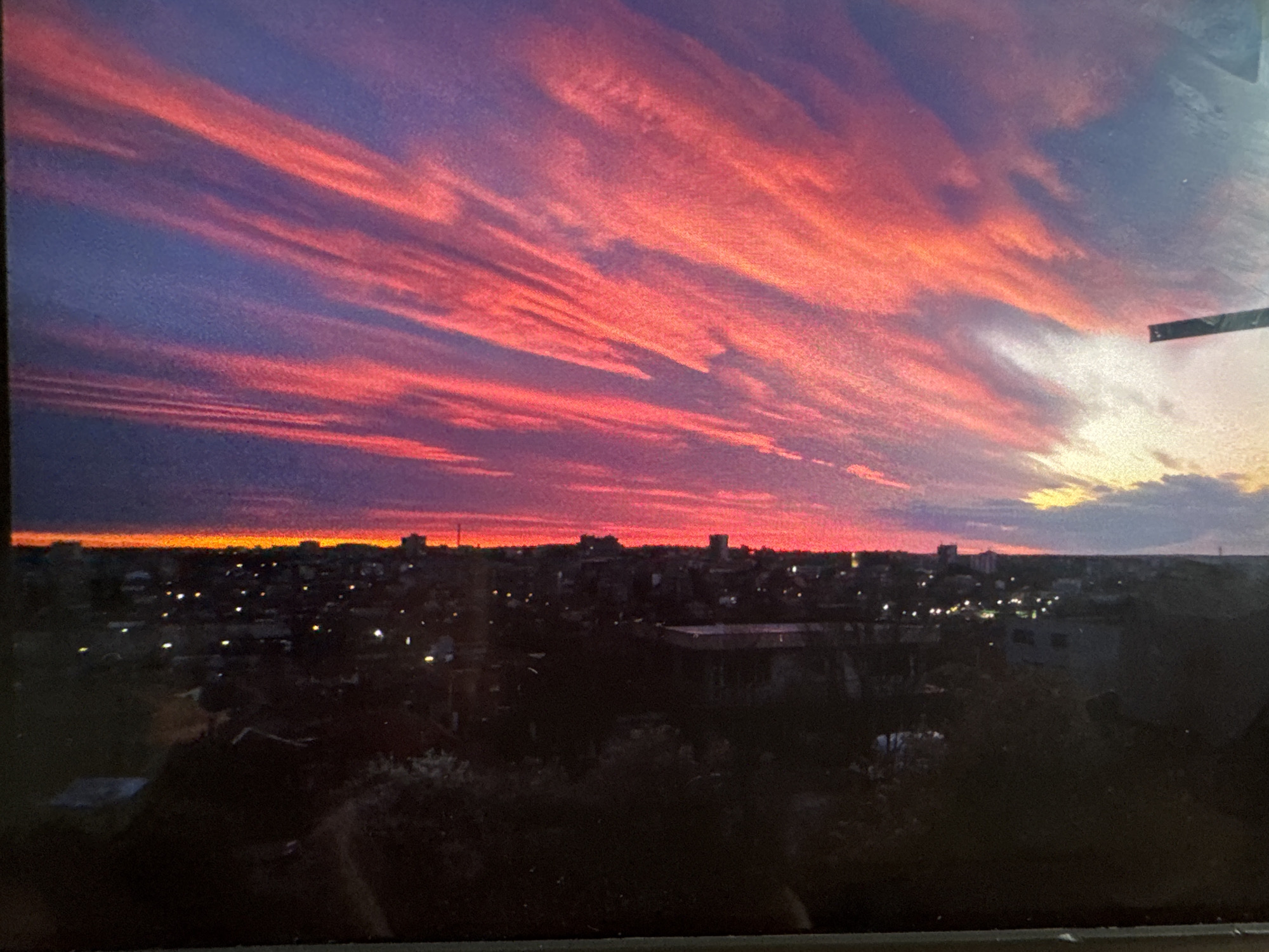 Colorful sunset illuminates Dobrich skyline with pink and purple clouds