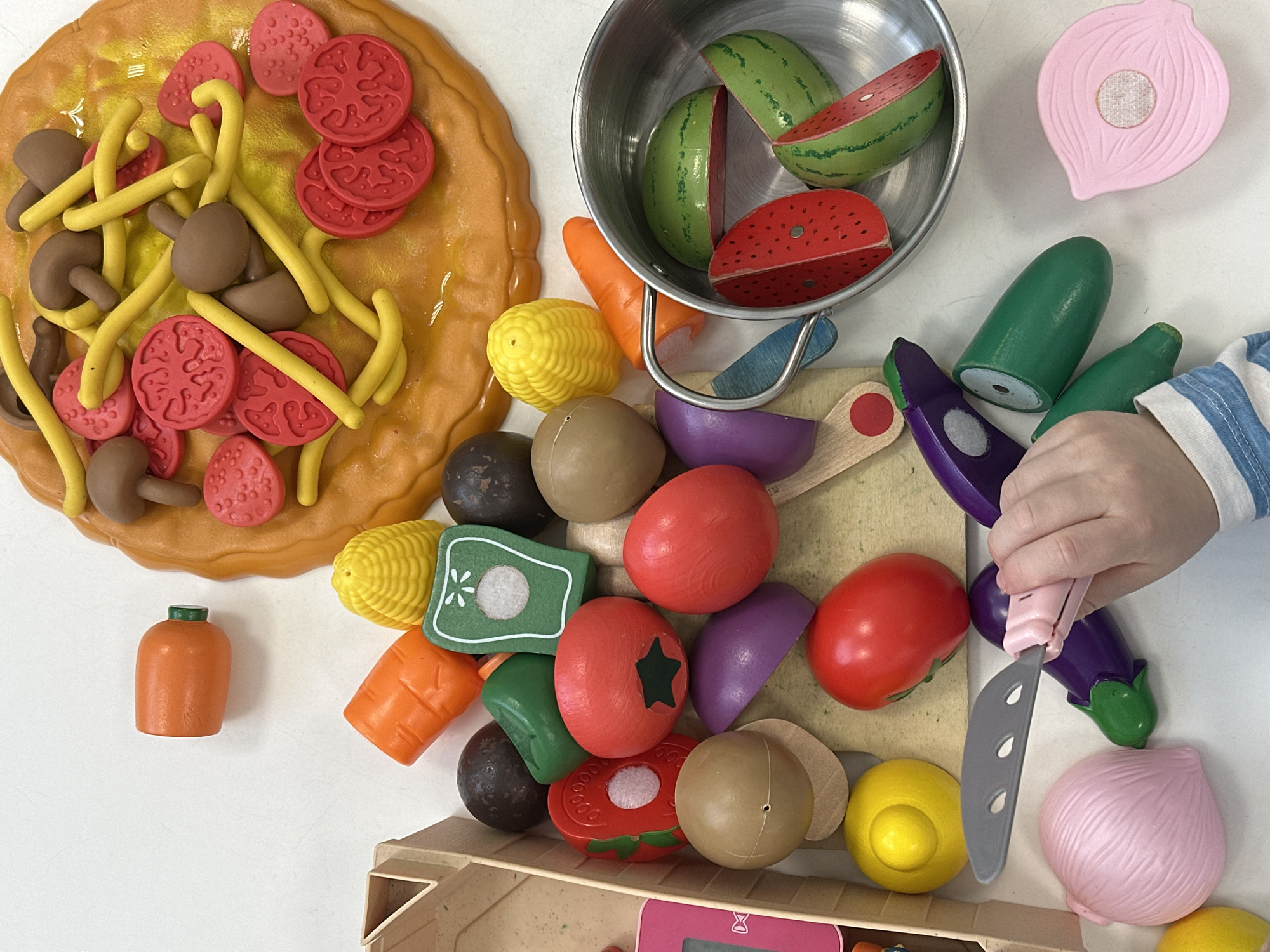 Child plays with toy food collection in Votkinsk
