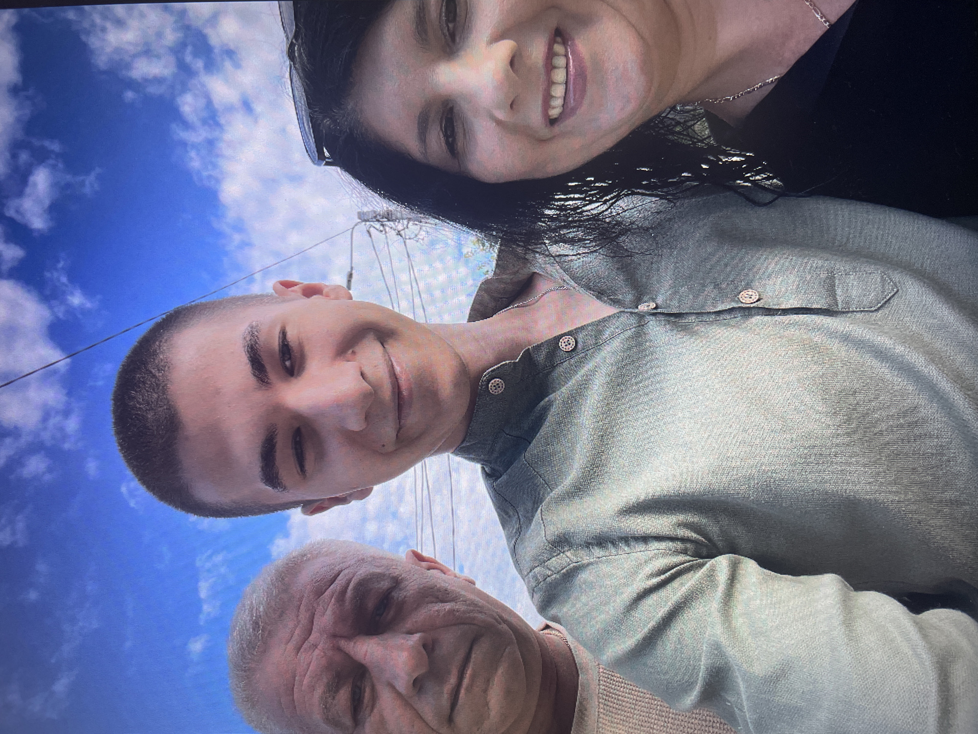 Three people pose for outdoor selfie in Iași