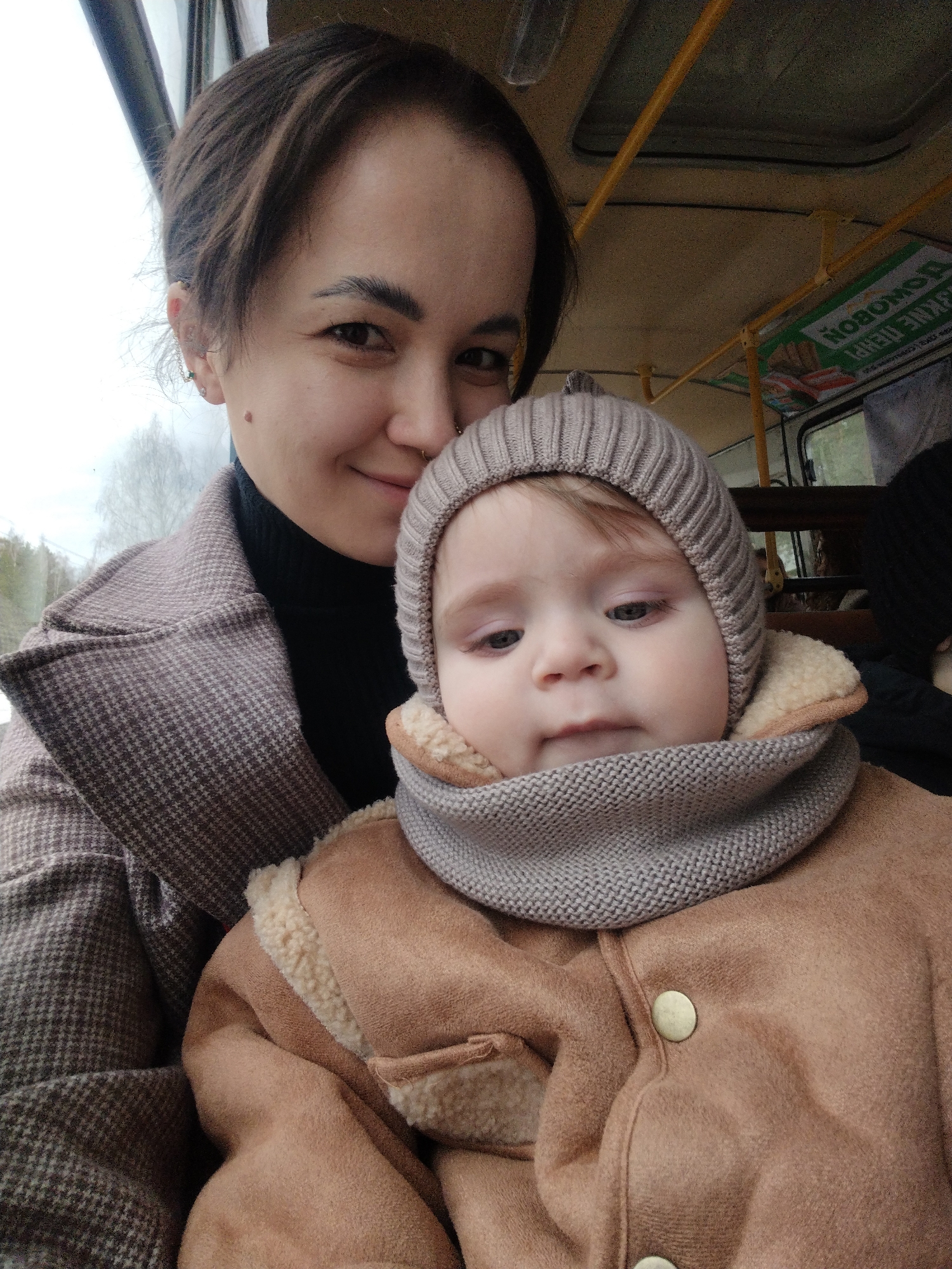 Woman and baby travel by bus in Noviy, Russia