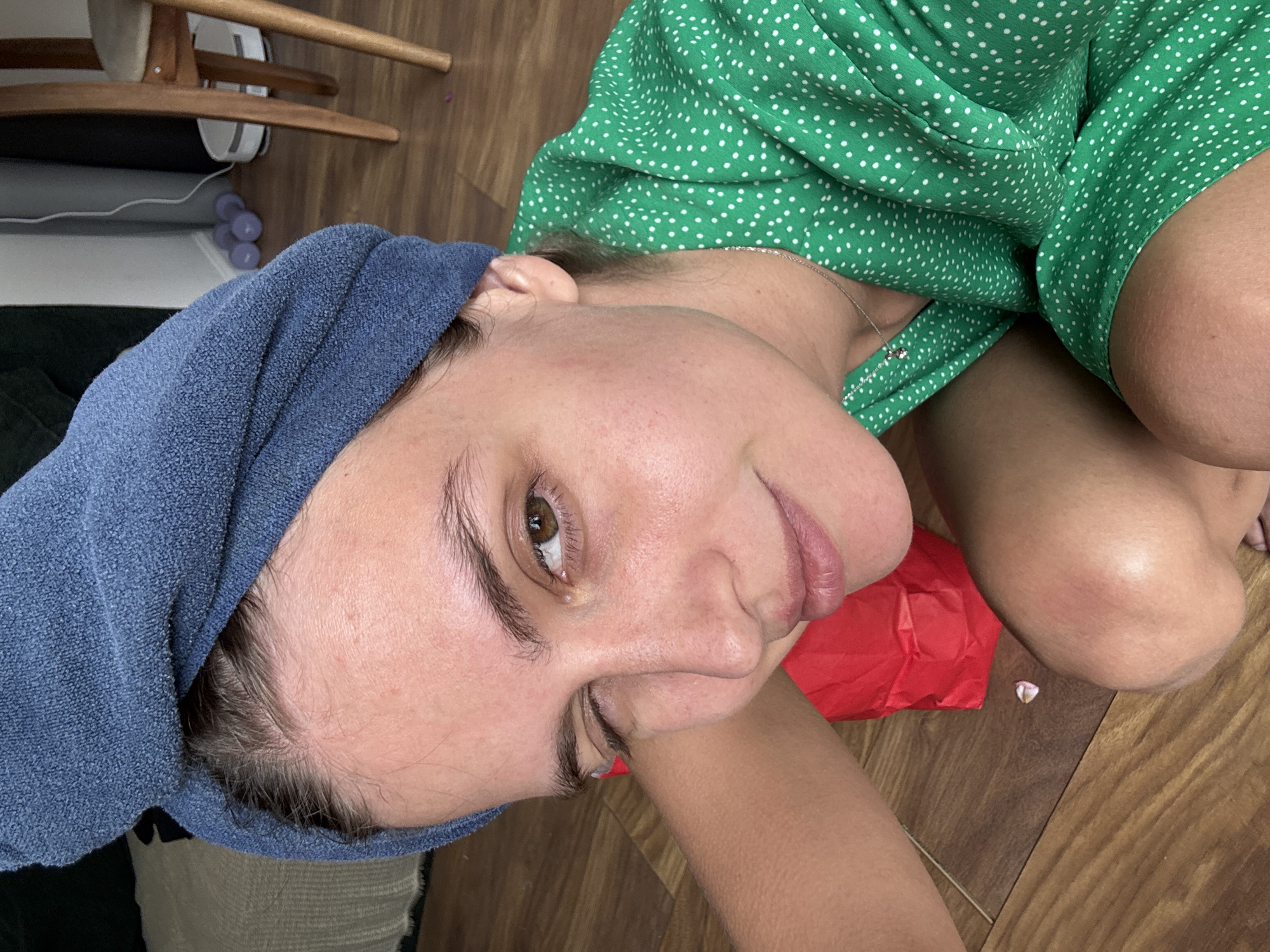 Person rests on floor in polka dot dress