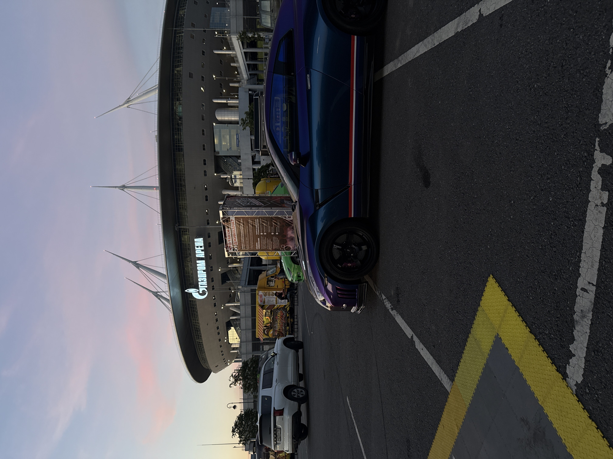 Gazprom Arena's curved exterior on a summer evening in St. Petersburg