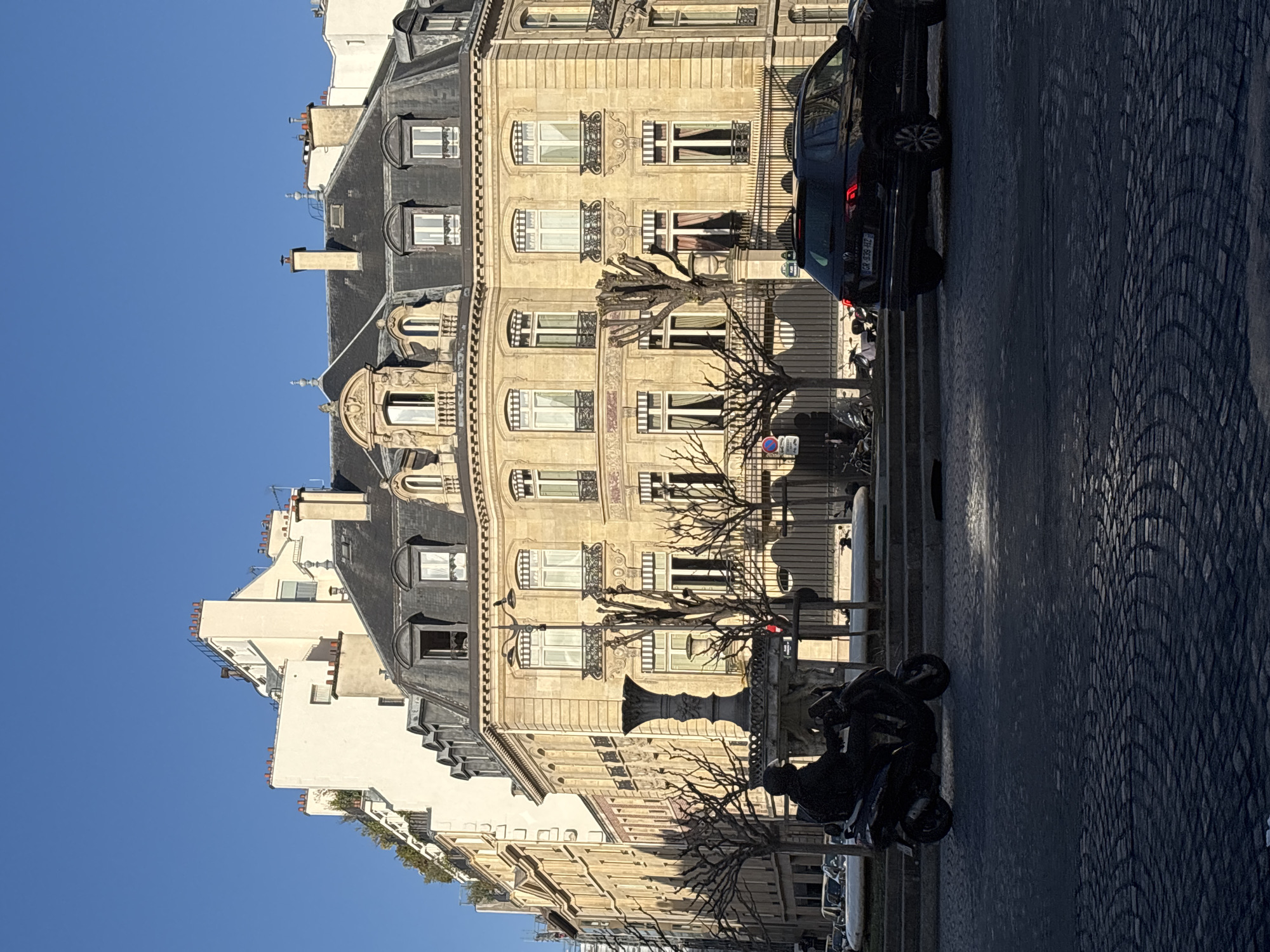 Morning street scene with parked vehicles in Paris