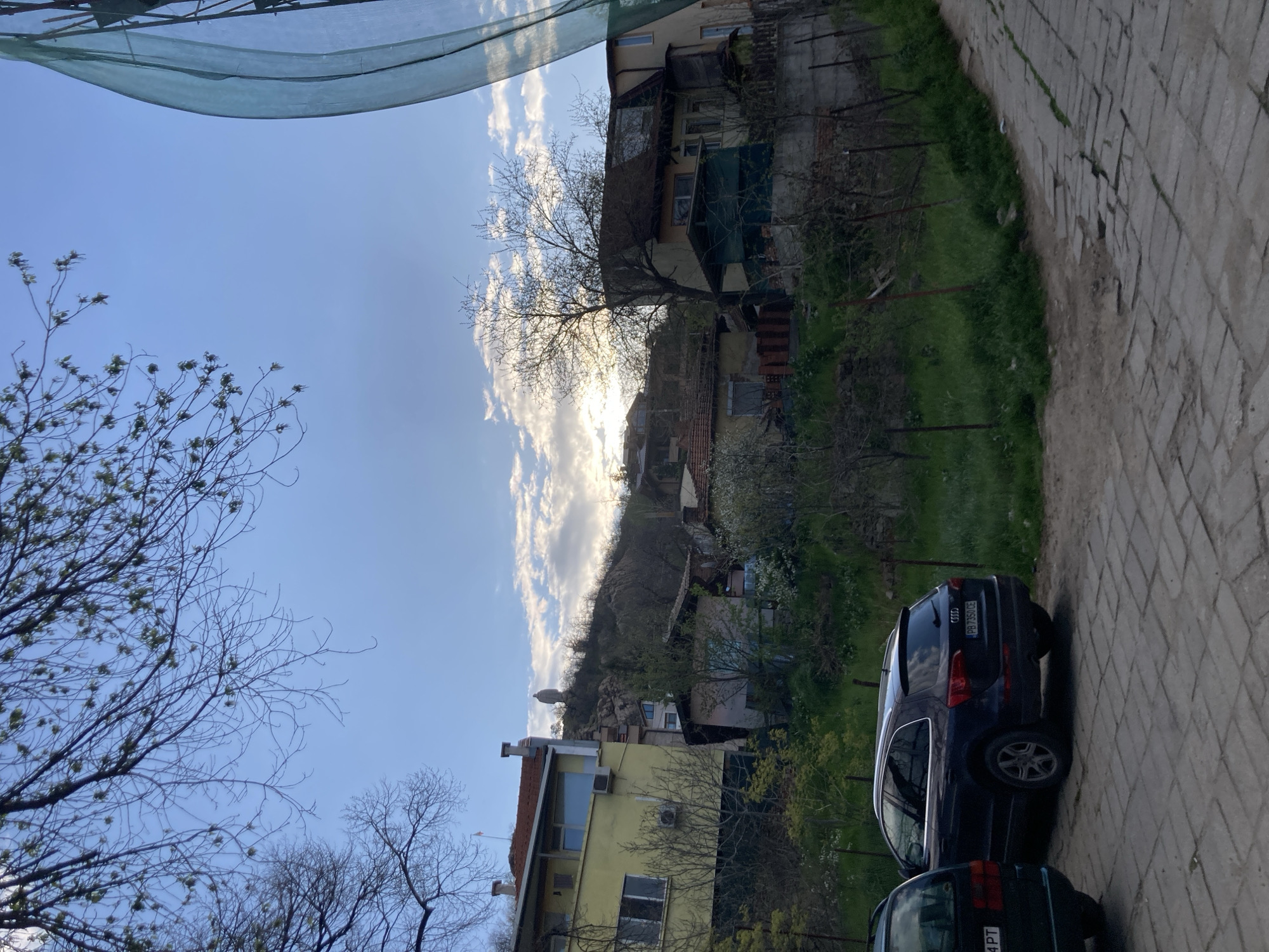 Street scene with parked vehicles documented at unknown location