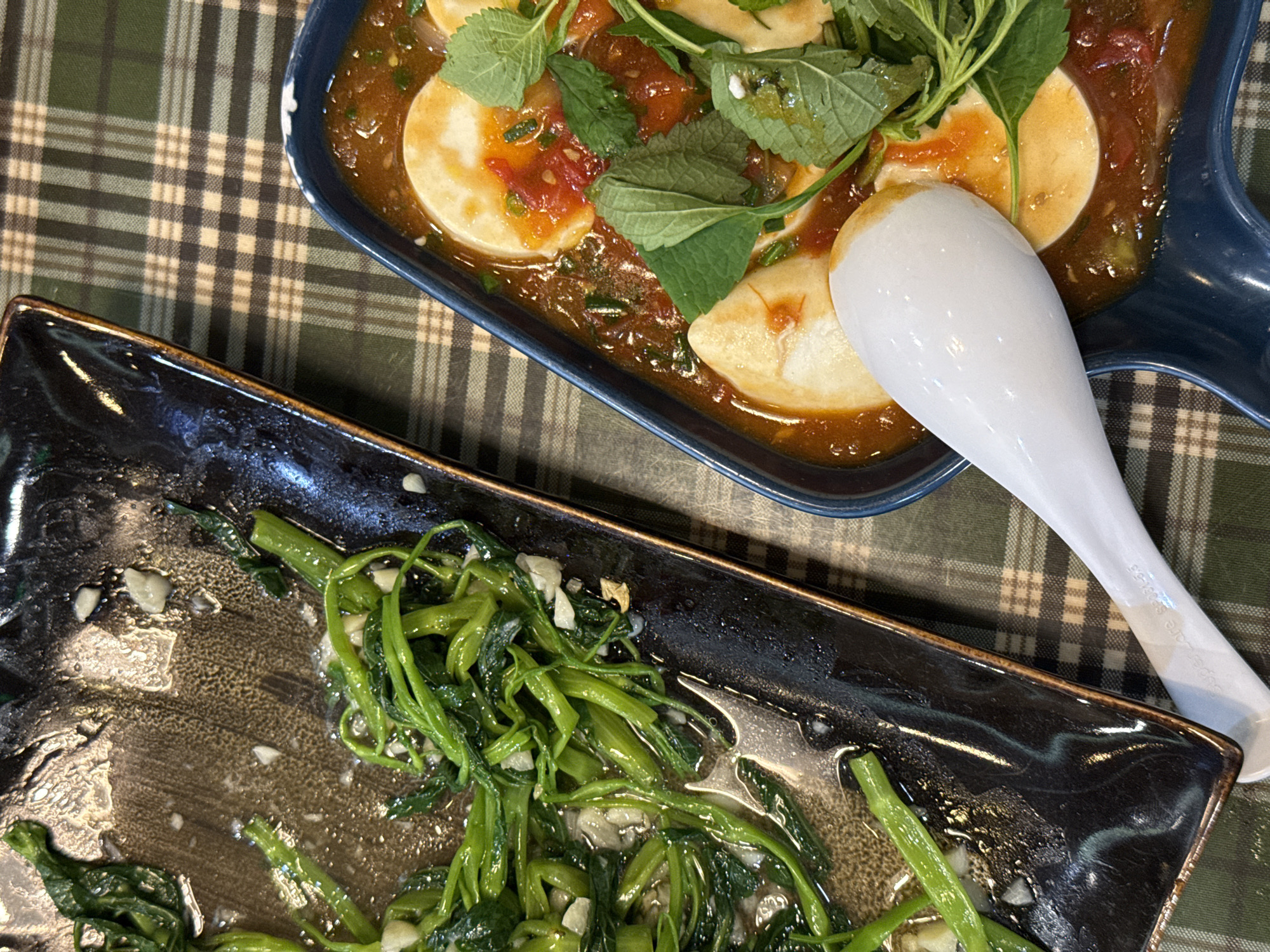 Meal photographed from above on checkered tablecloth in Hanoi