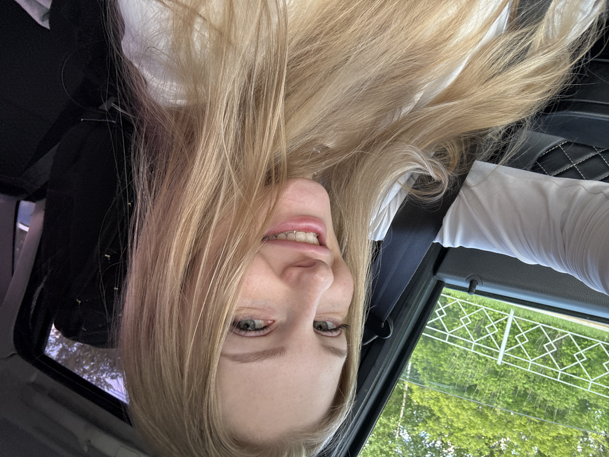 Woman takes playful selfies in car in Perm, Russia