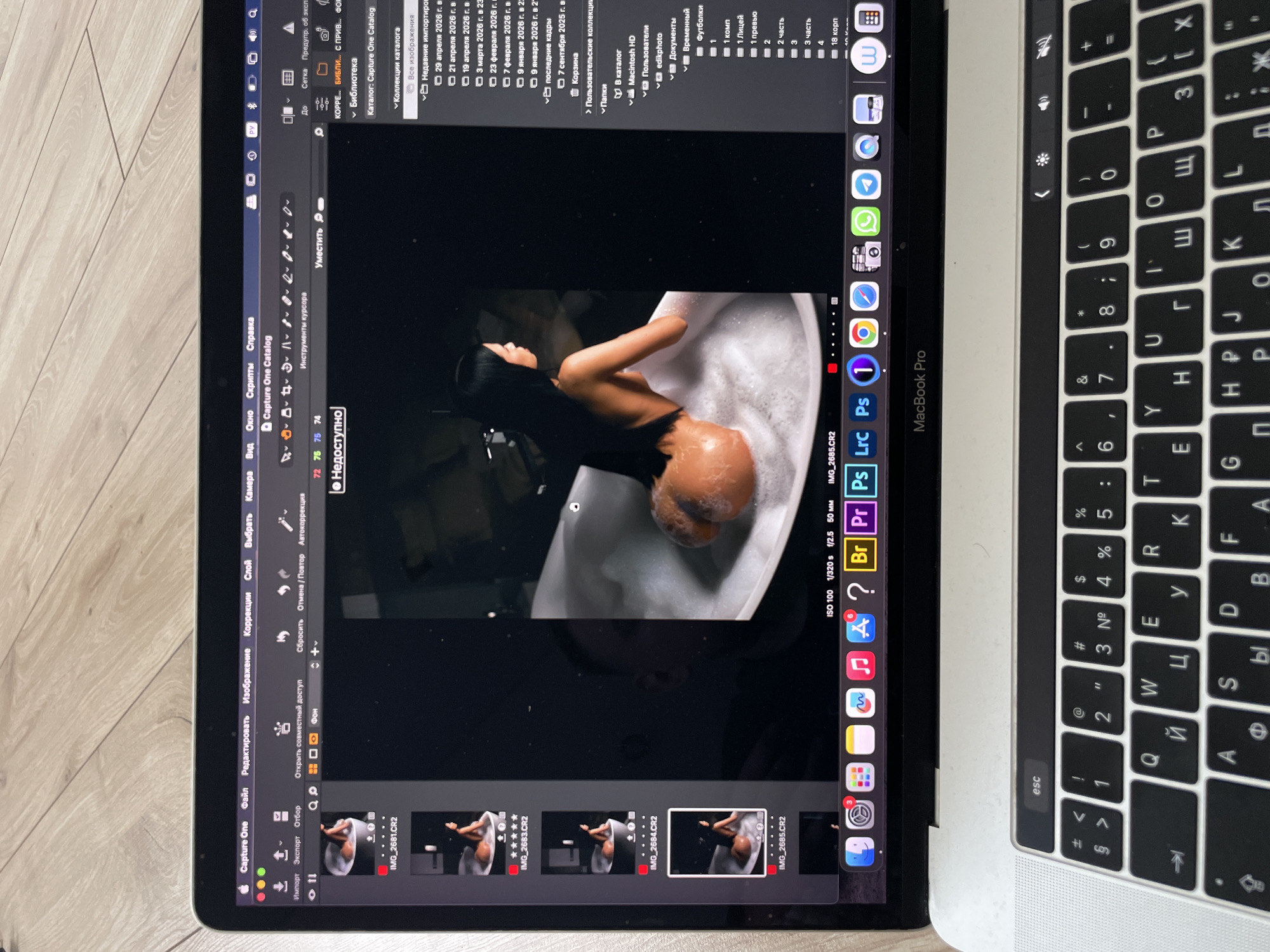 Photographer edits portrait sessions on laptop in Kazan