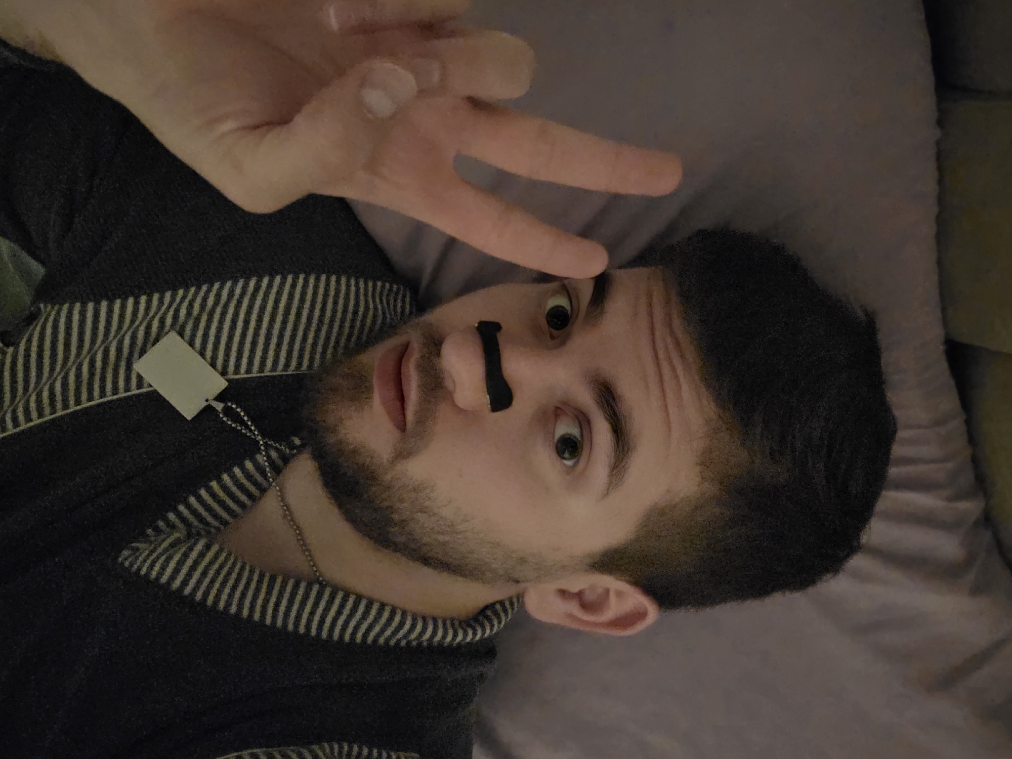 Man with nose strip poses on couch in Bulgaria