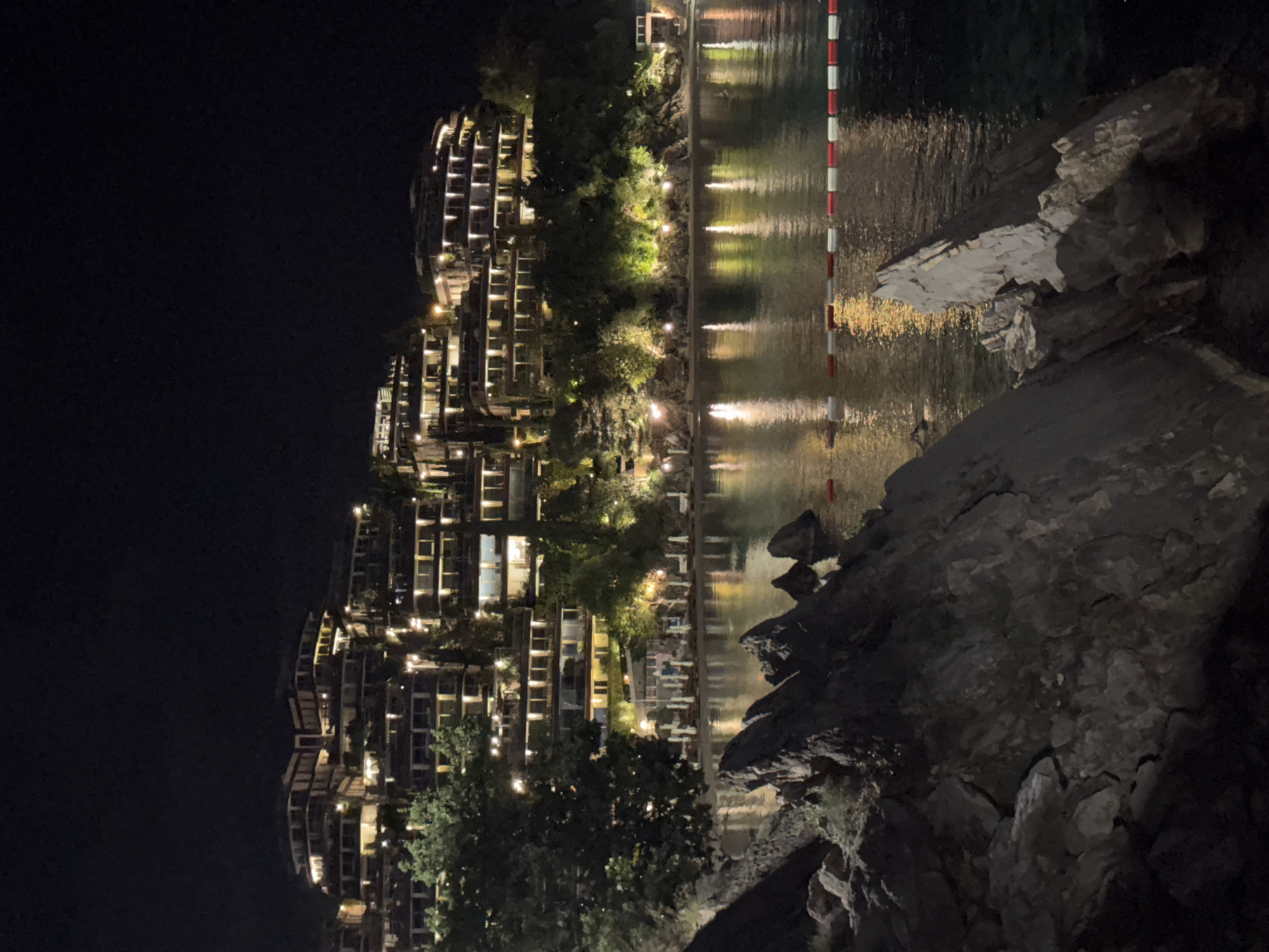 Evening lights illuminate Budva waterfront cafes and residential areas