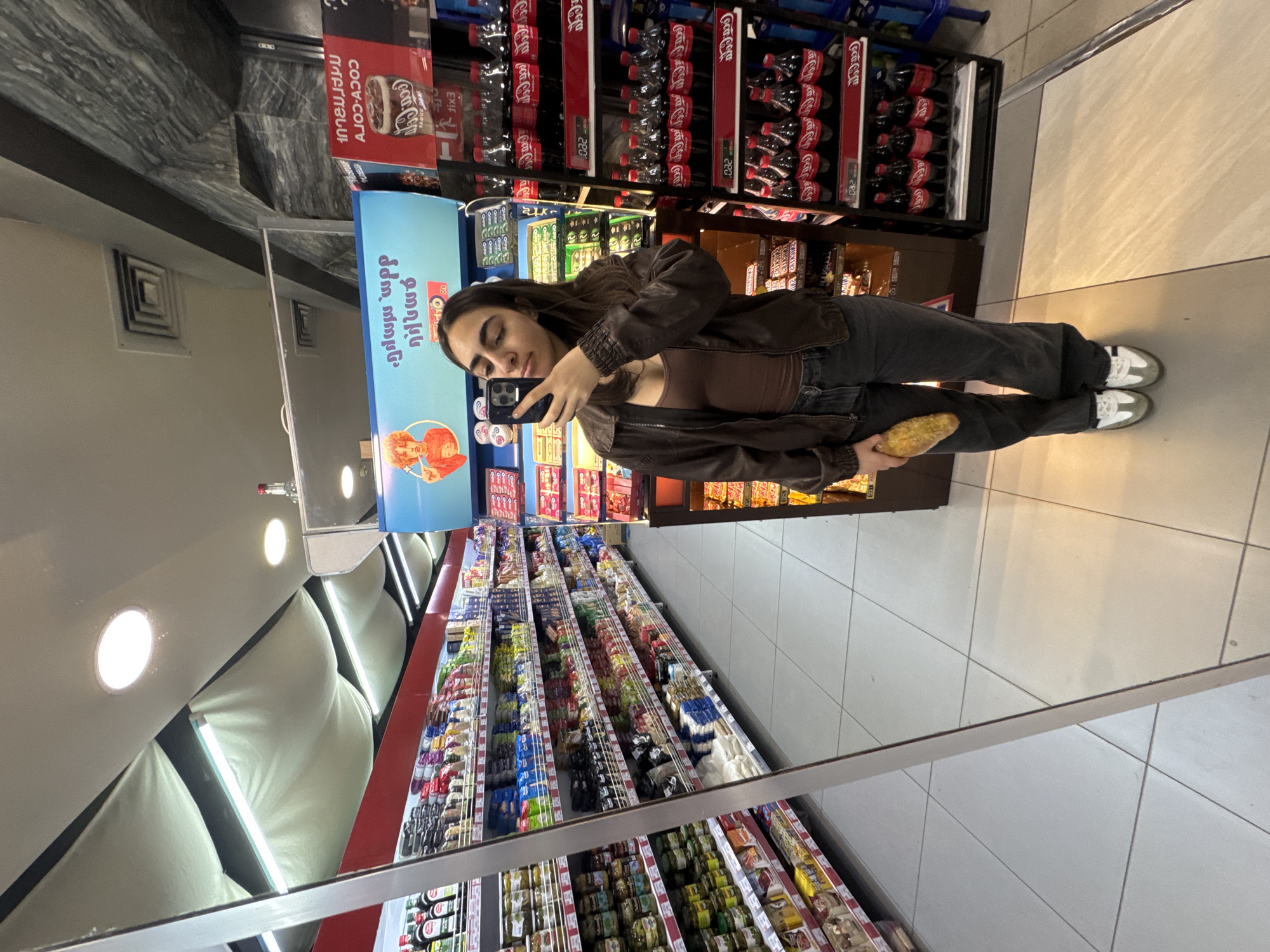 Woman takes mirror selfie in Yerevan supermarket