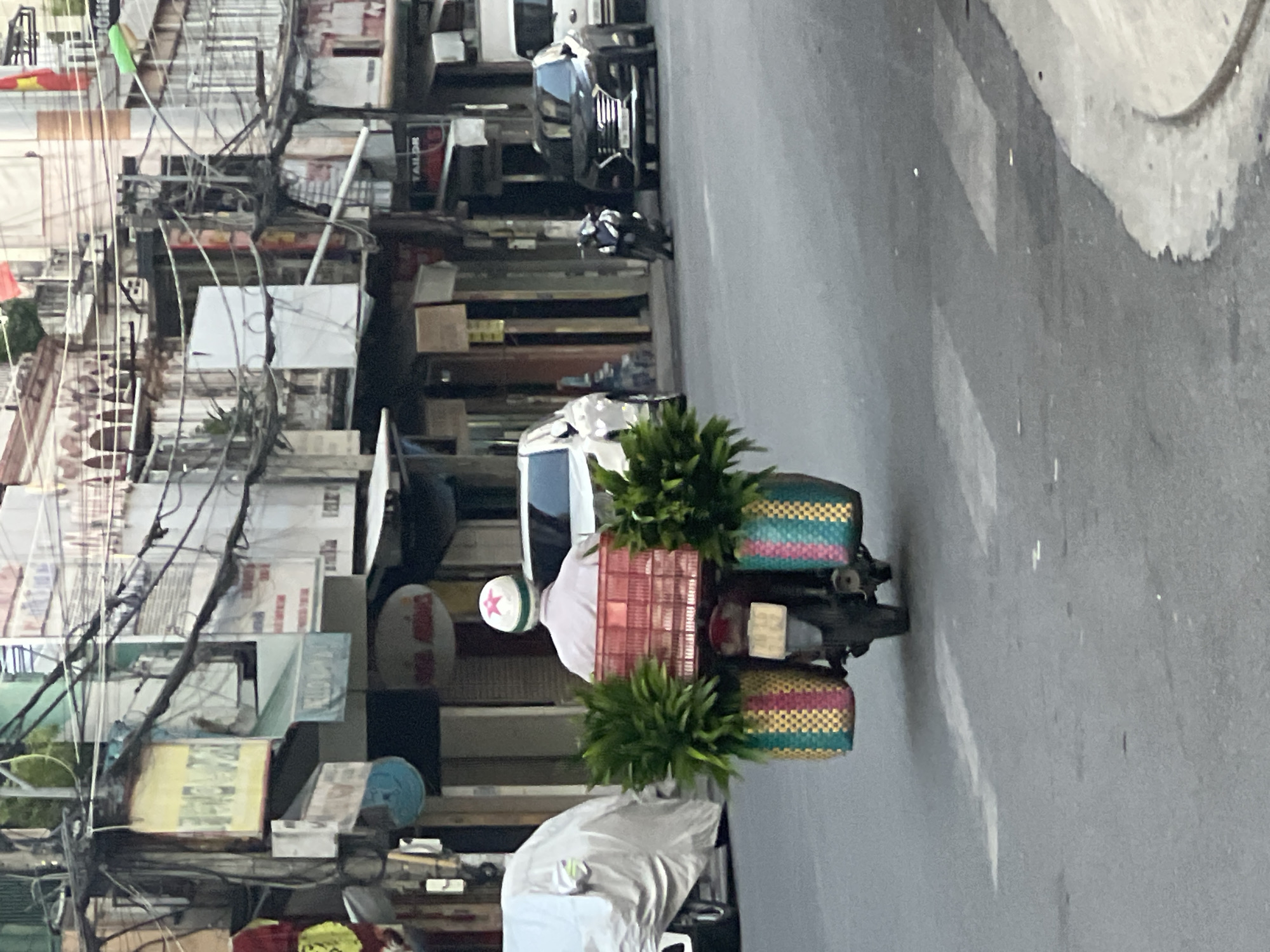 Evening street life in Nha Trang, motorcycles, EVs, and city storefronts