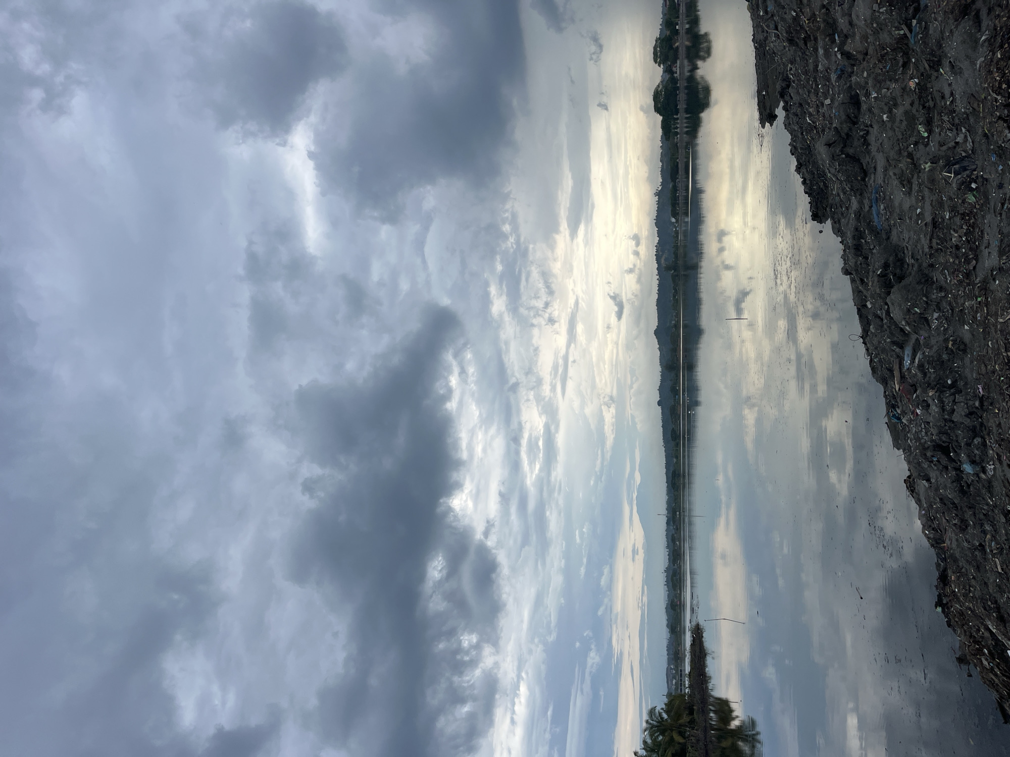 Cloudy skies reflect over waters near Lhokseumawe, Indonesia
