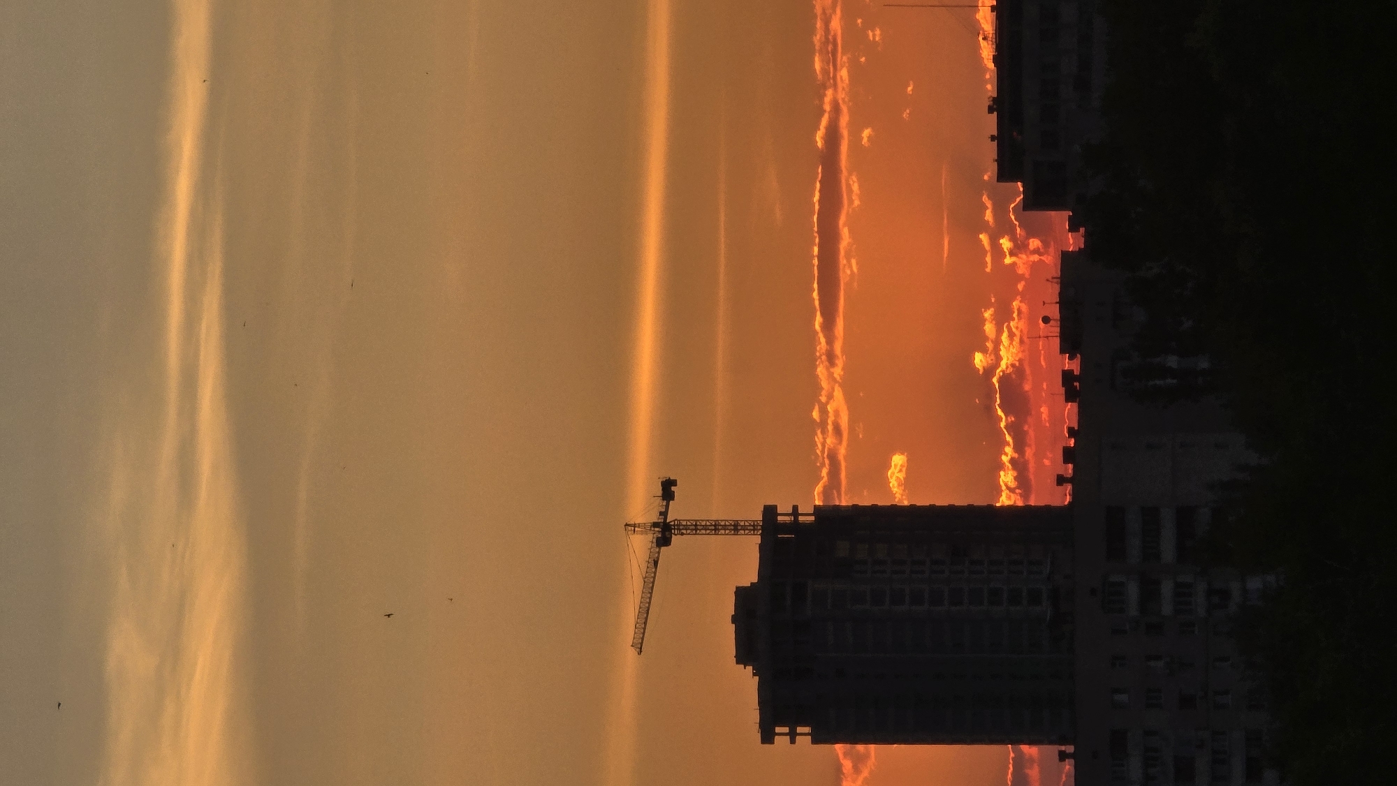Warm orange sunset lights up the Kyiv sky