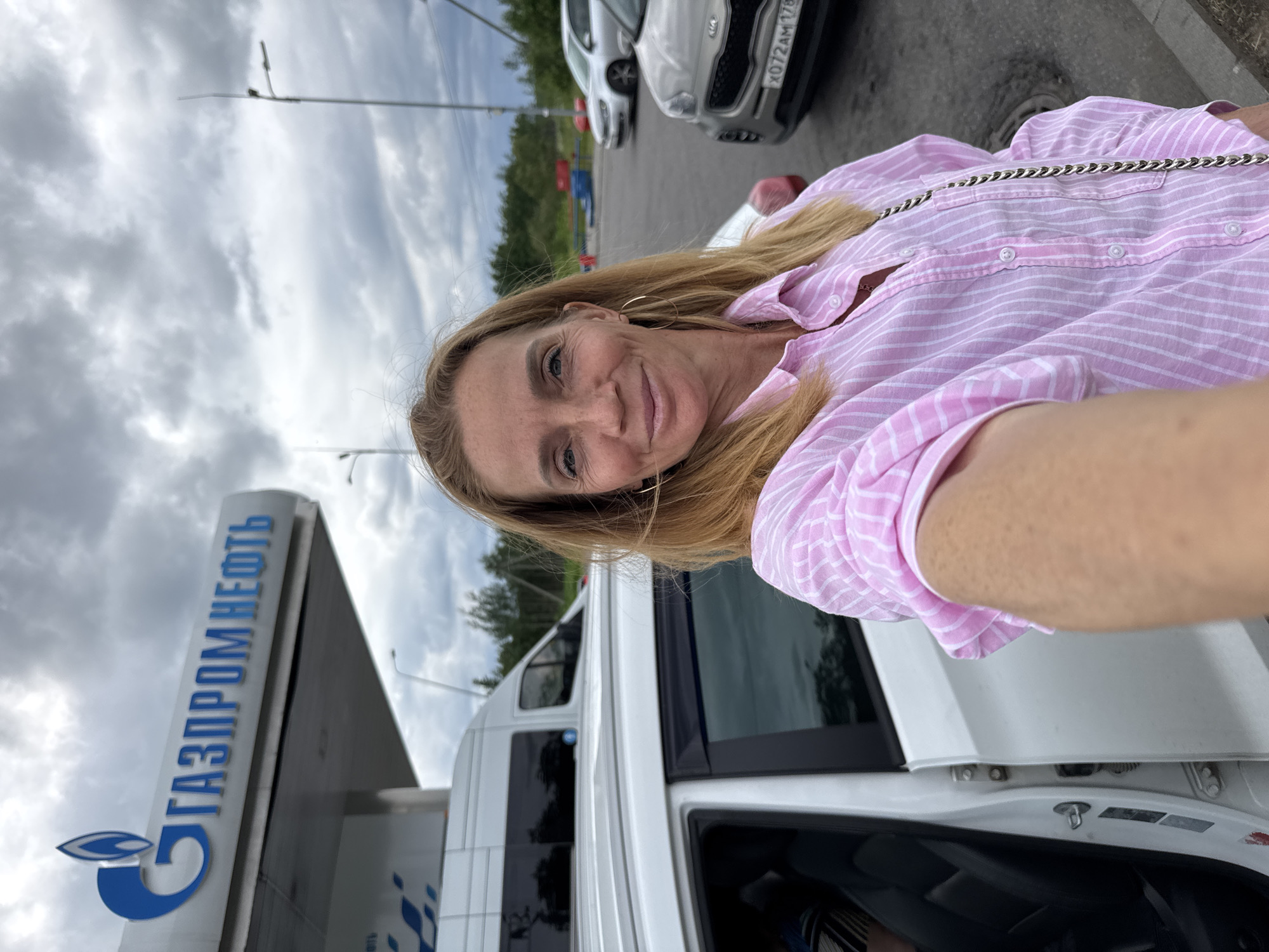 Woman takes selfies at Russian gas station