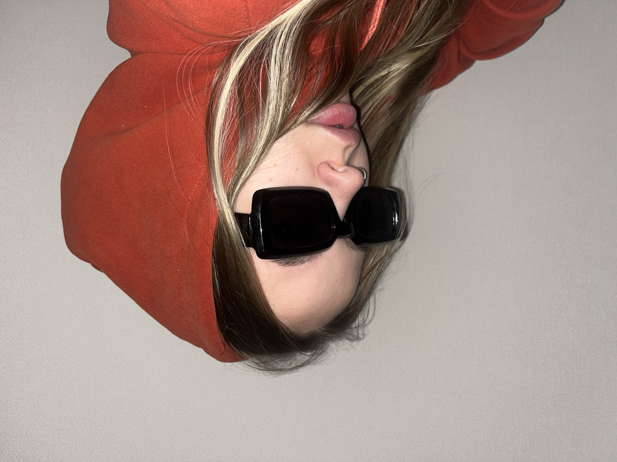 Person in orange hoodie photographed upside-down in Krasnodar