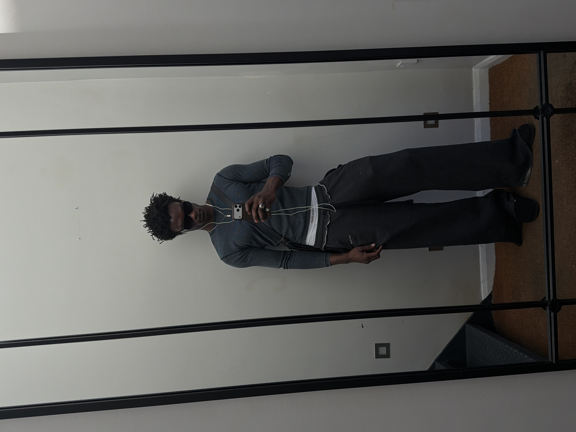 Man in grey clothing observed at mirror in London