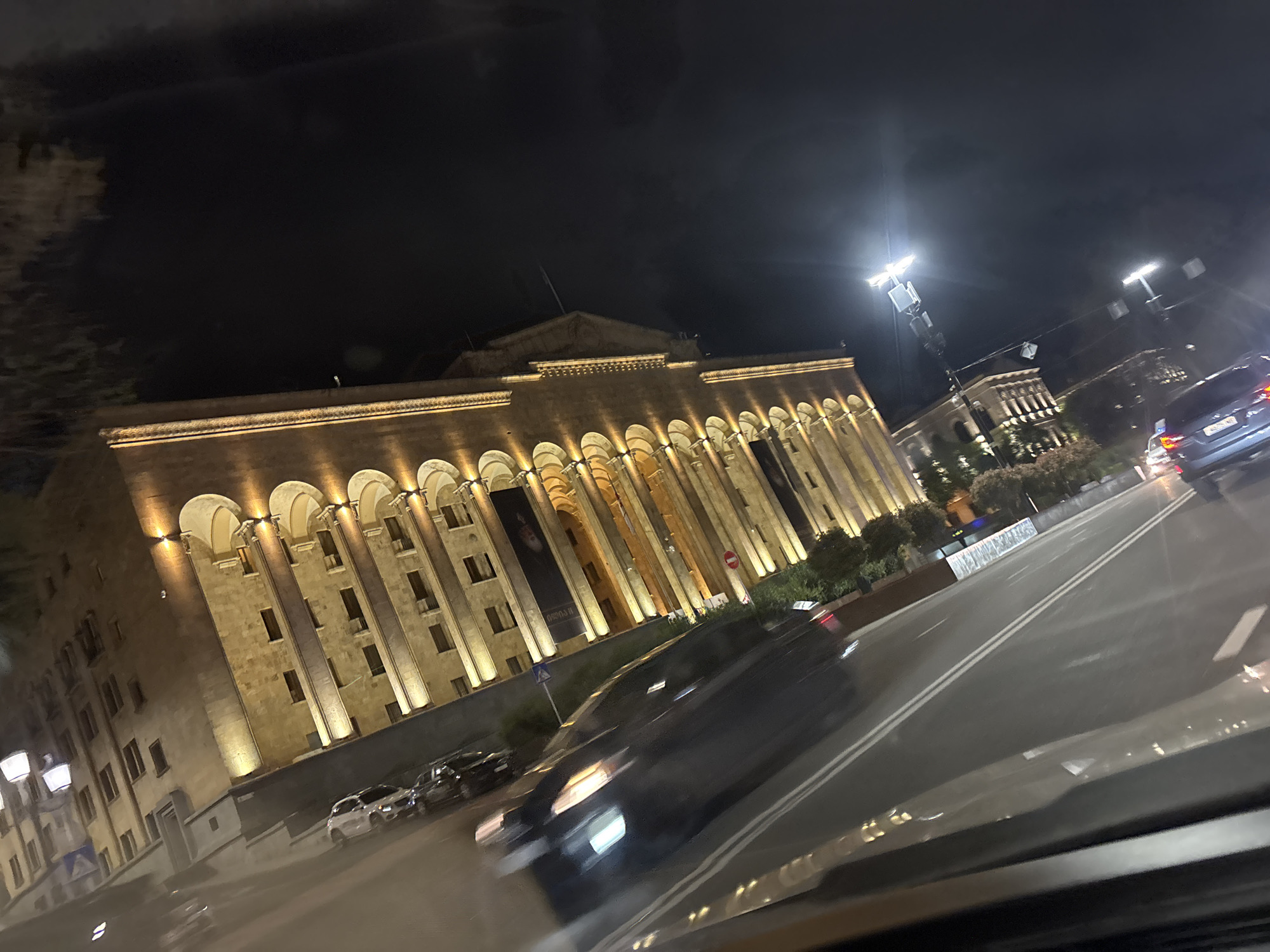 Nighttime drive through downtown Tbilisi captures illuminated landmarks