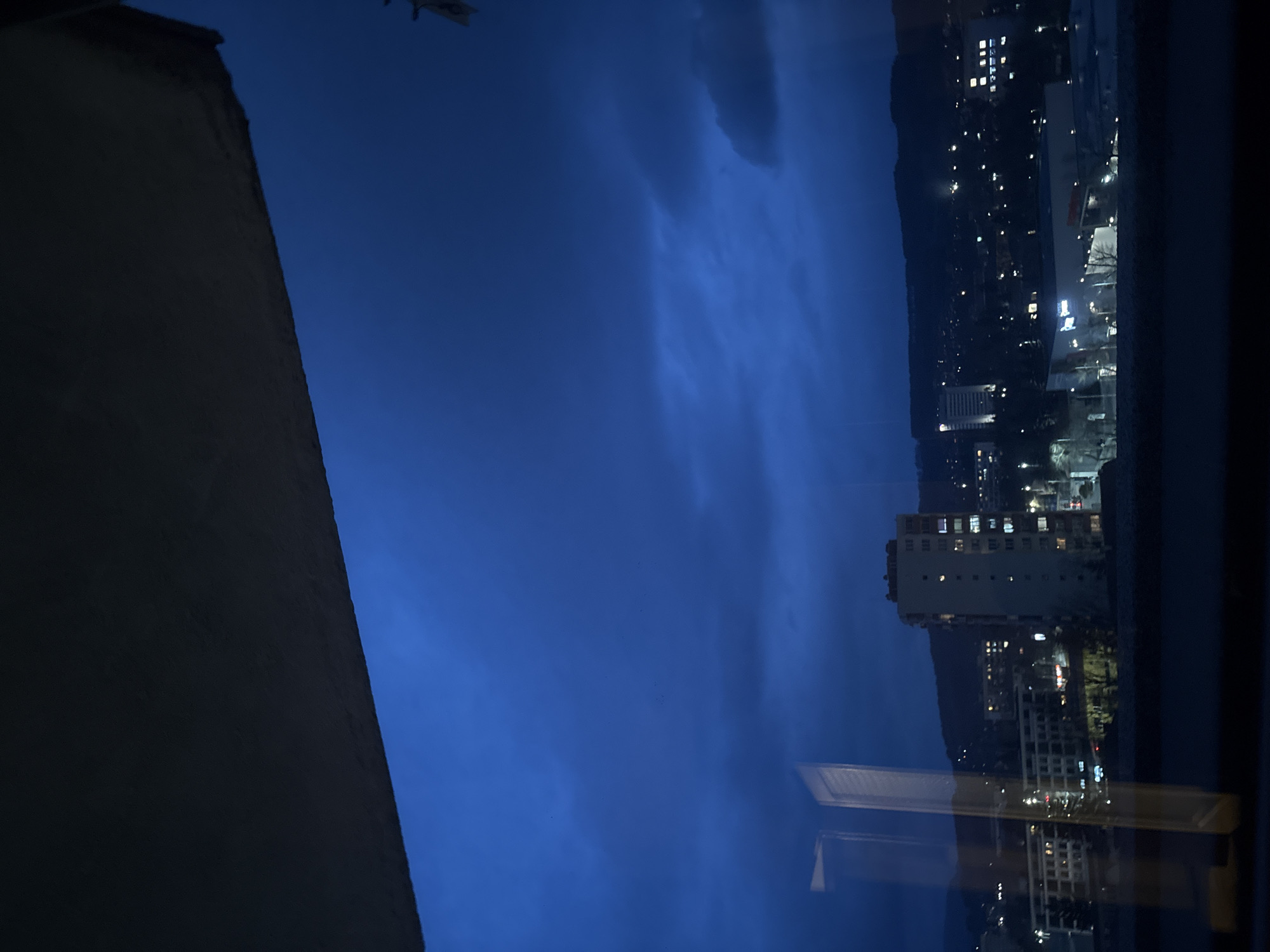 Night view of illuminated Pernik cityscape from window