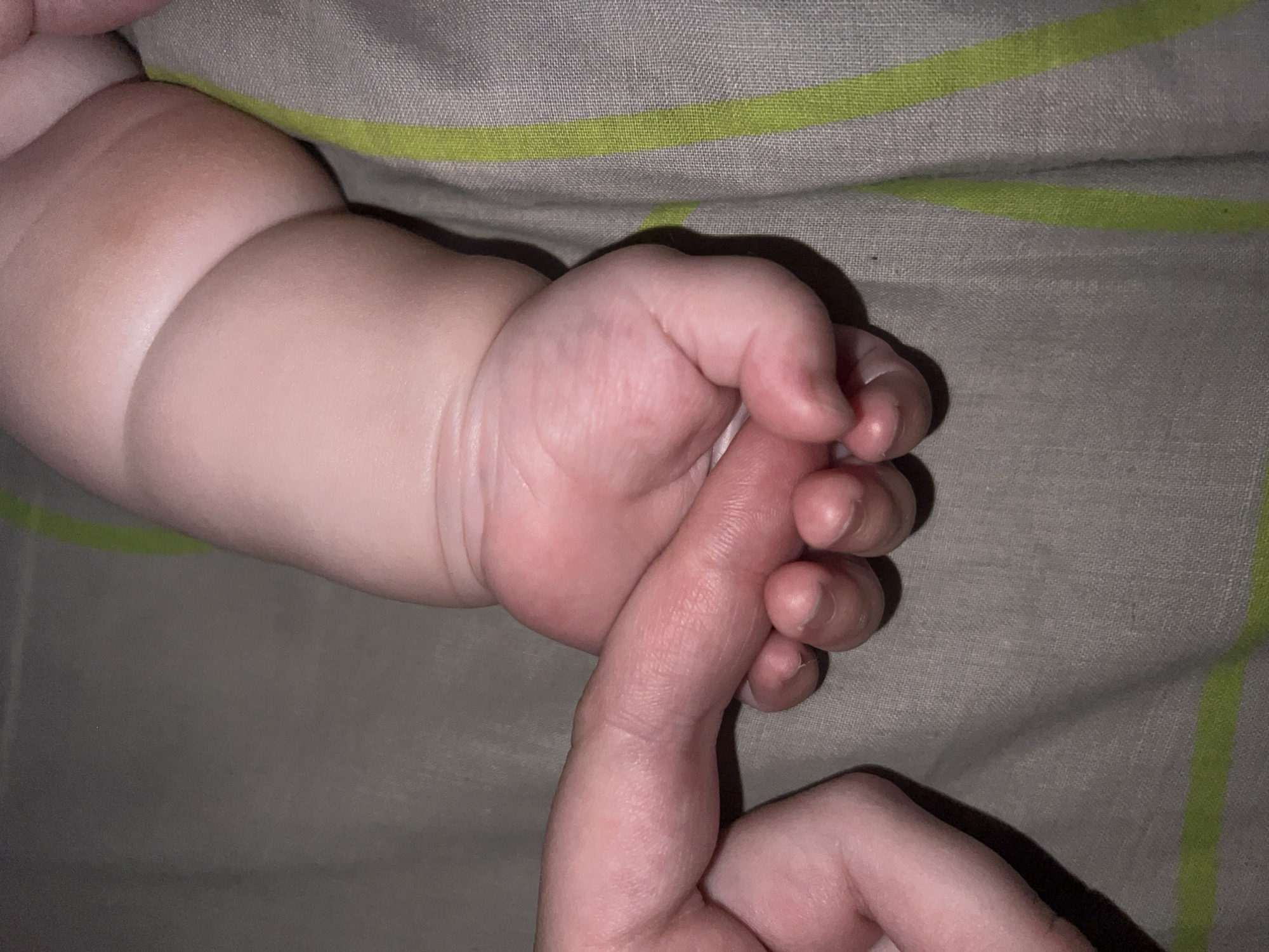 Tender adult-baby bonding moments captured in intimate indoor setting