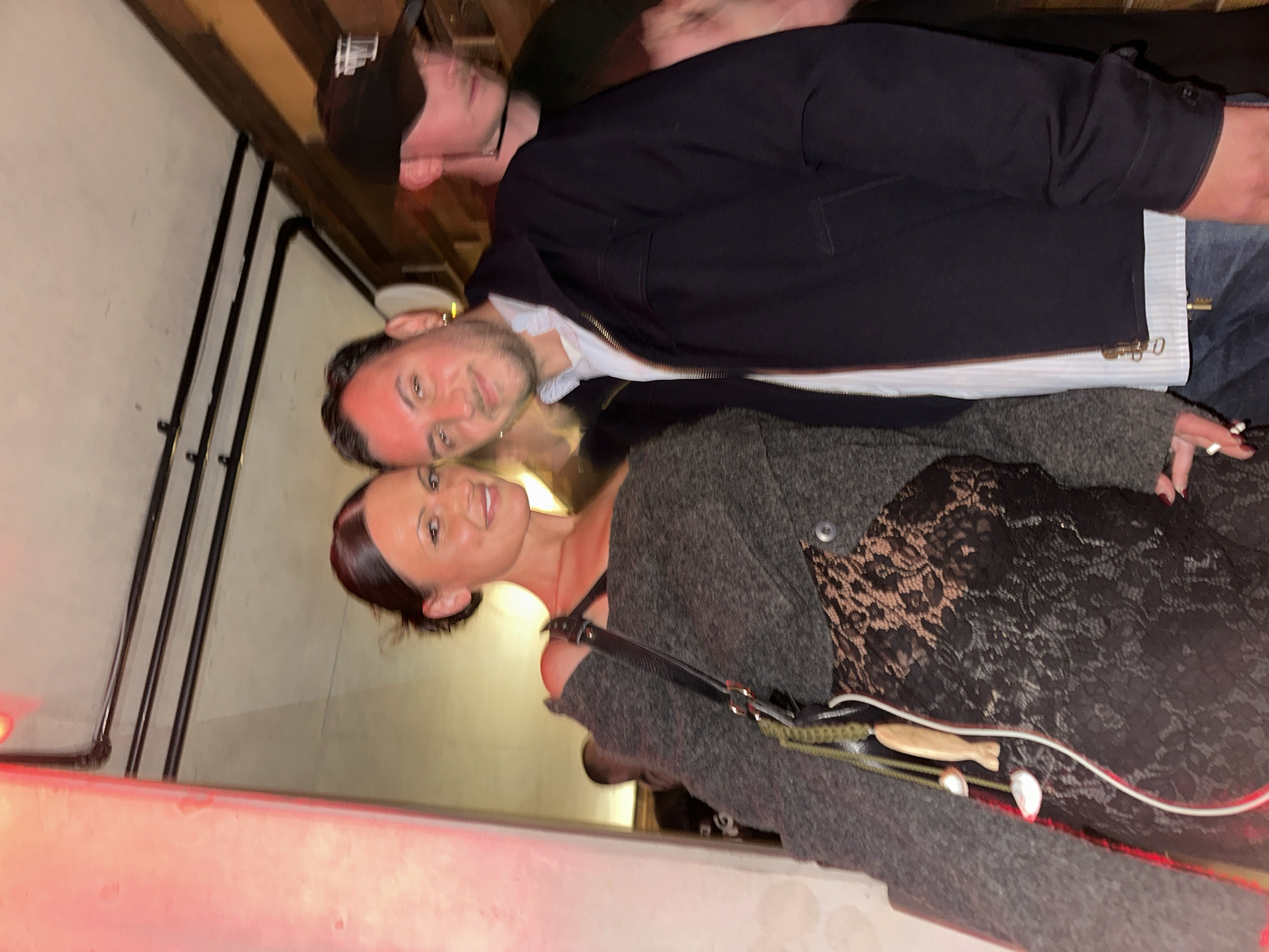 Three people gather at London bar during evening