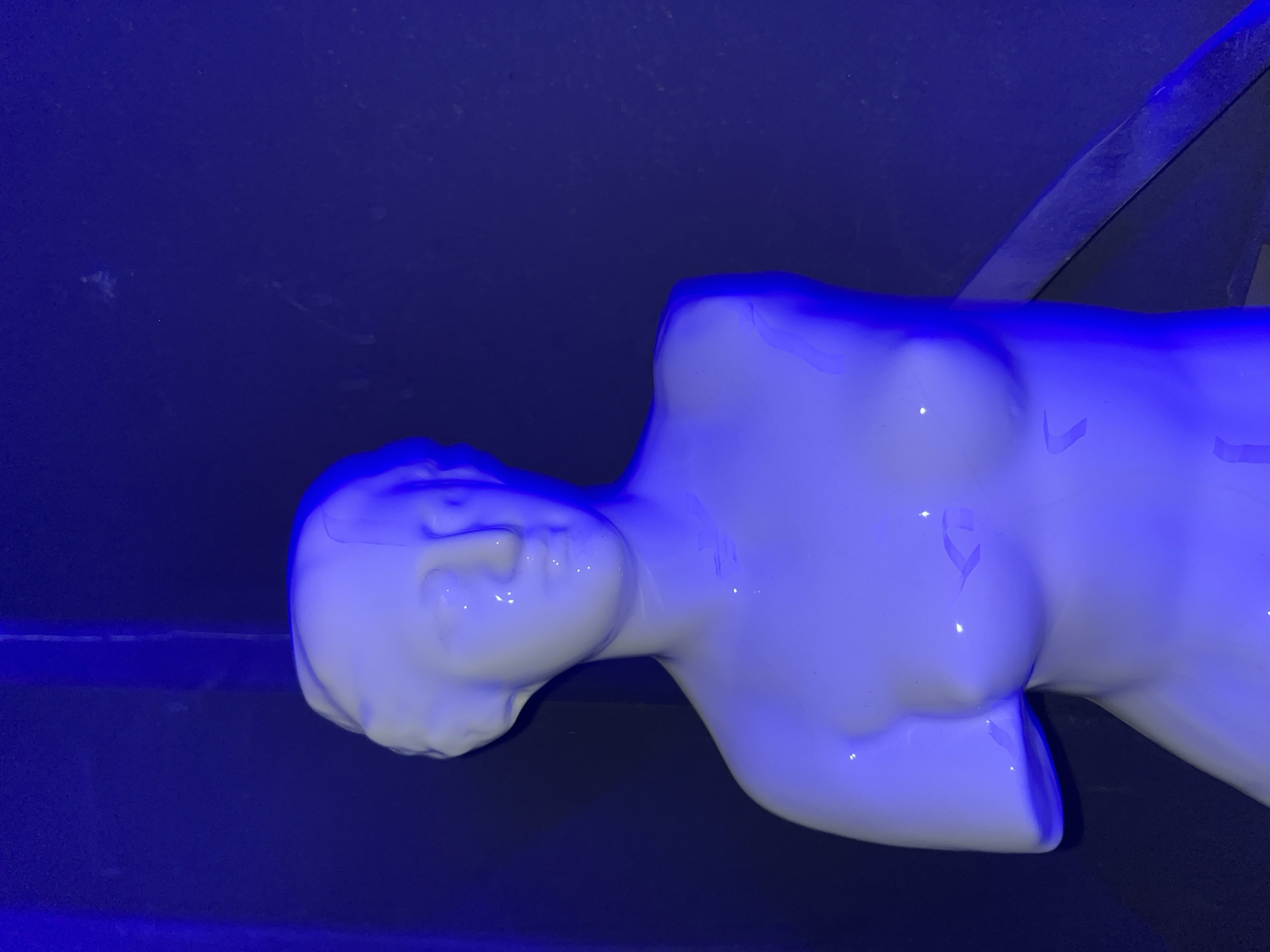 White mannequin displayed in blue-lit Accra bar early Monday