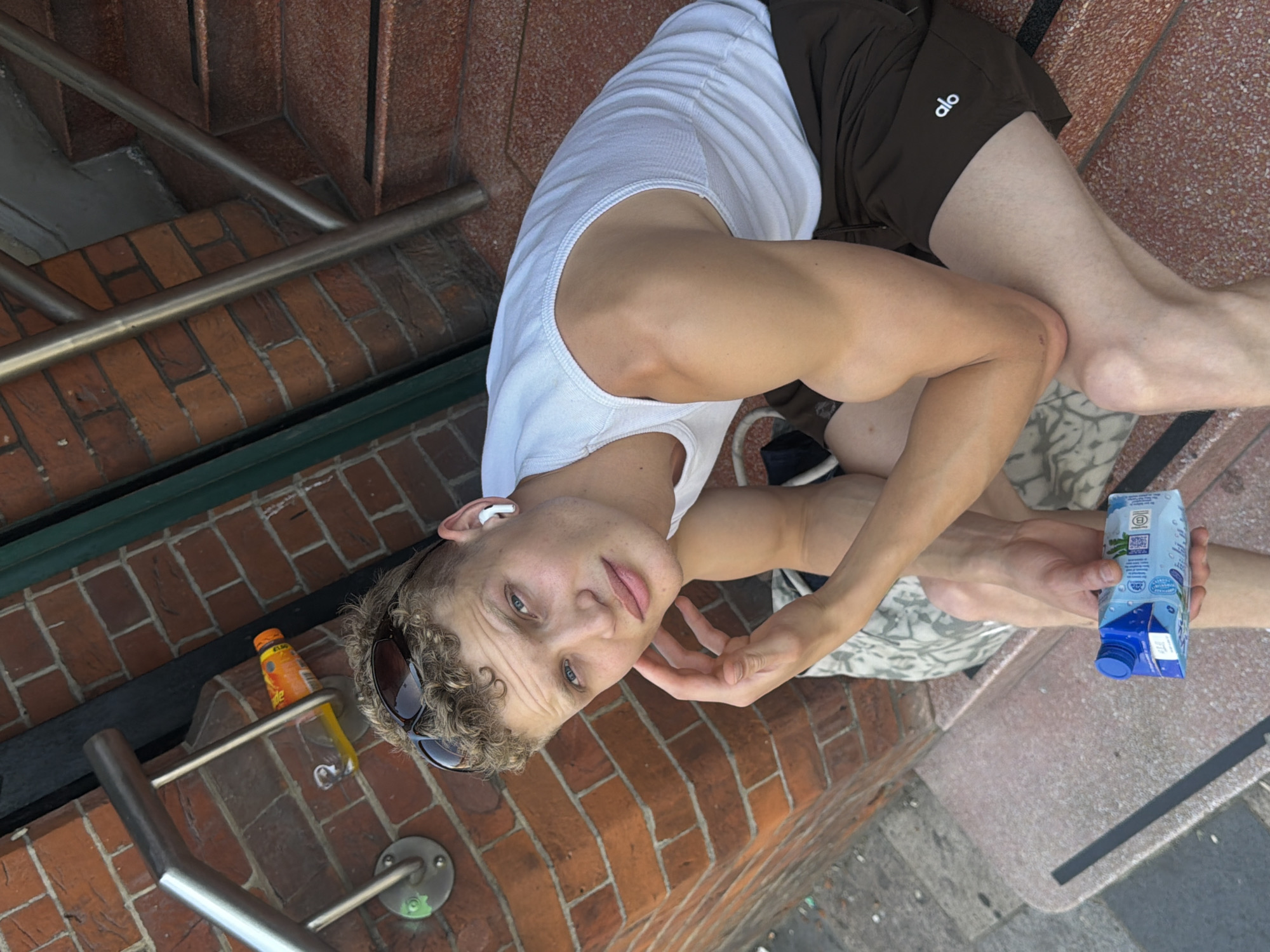 Chilling on London outdoor steps, phone in hand