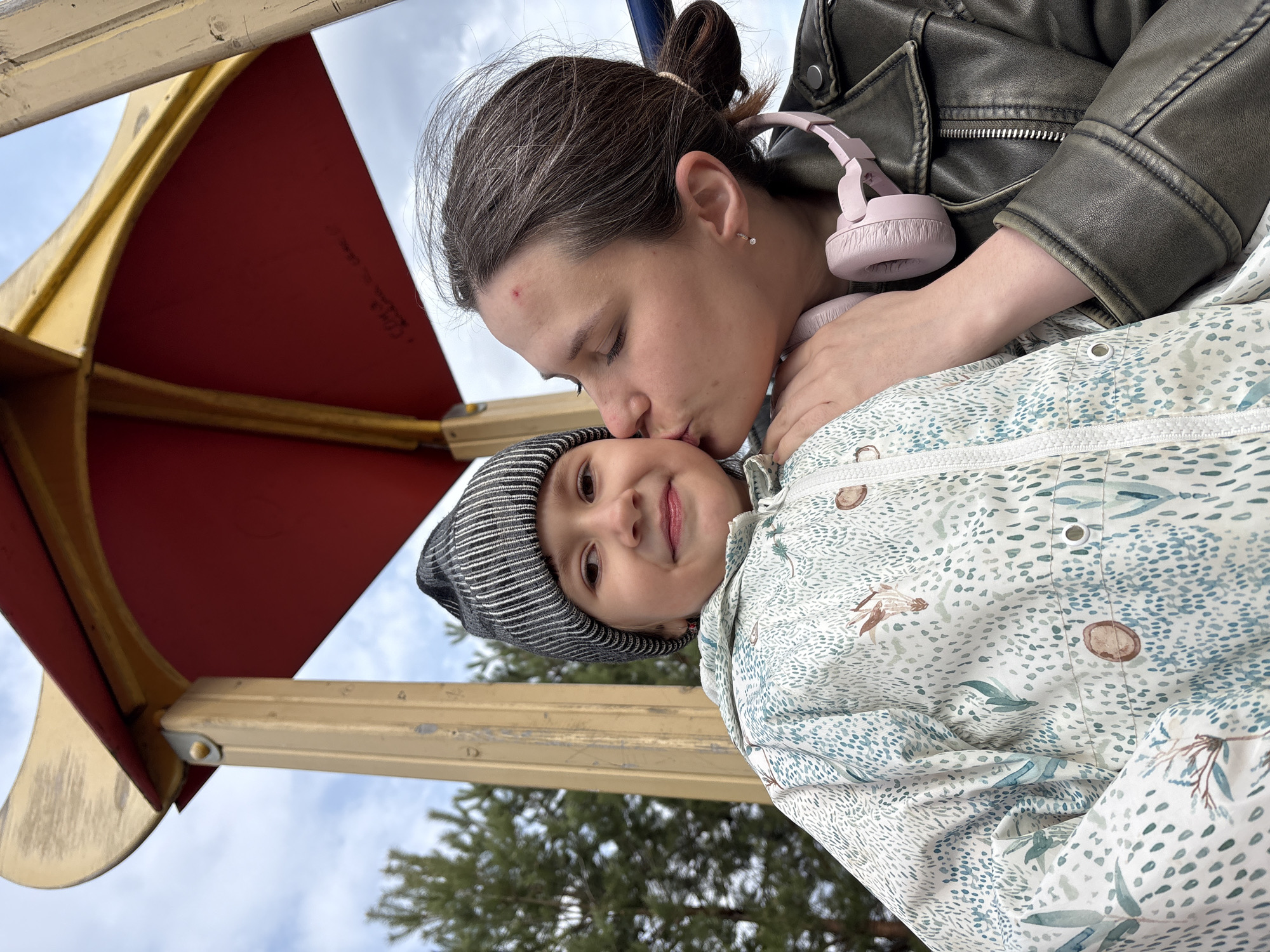 Woman and child share moment on Chaikovsky playground
