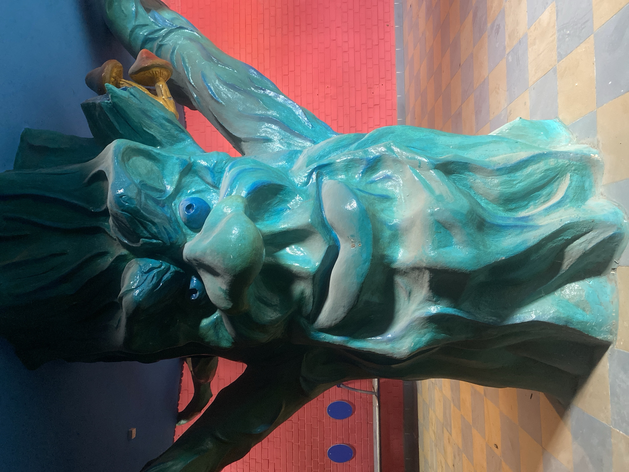 Fantastical sculptures including dragon and robot displayed indoors