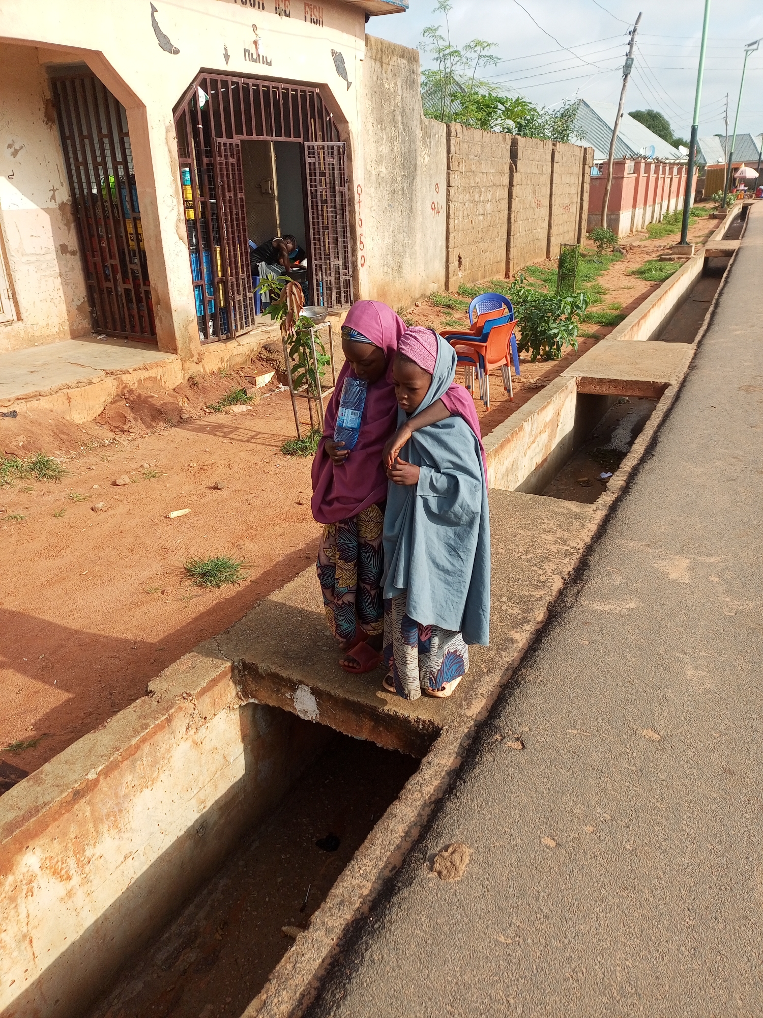 Everyday street and neighborhood life in a small African settlement