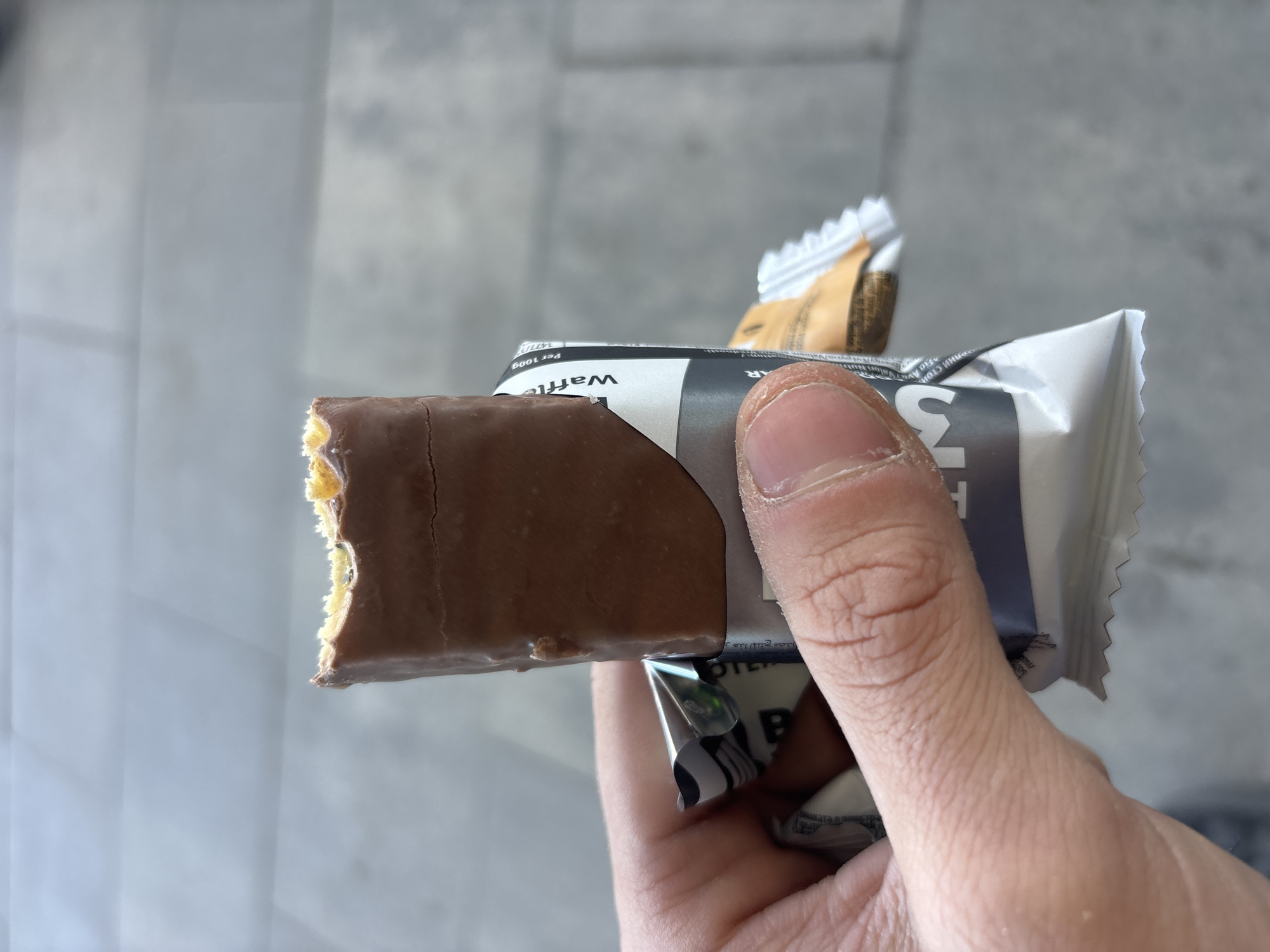 Person enjoys chocolate wafer bar in Plovdiv, Bulgaria