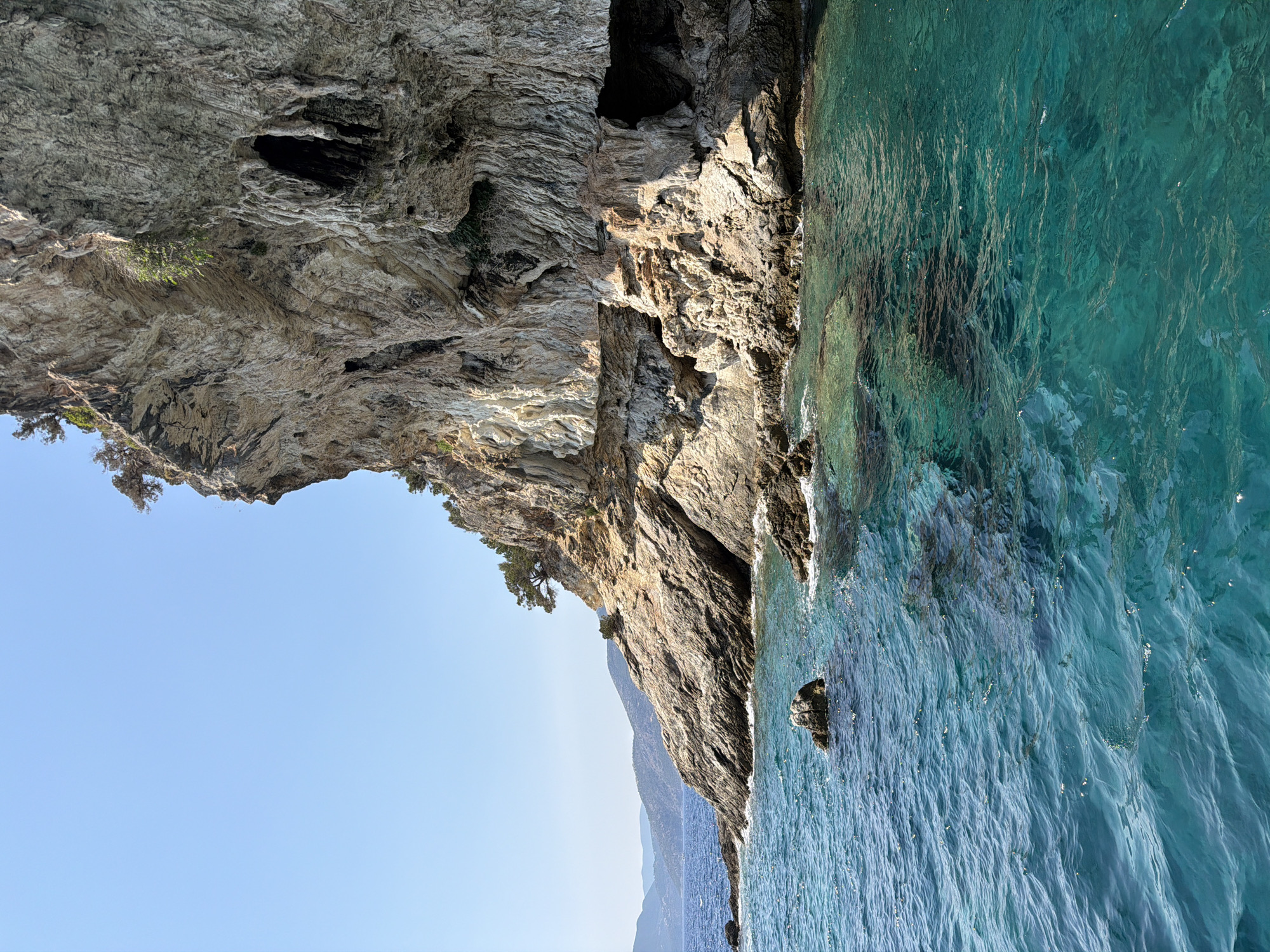 Sea cave and coastal cliffs explored by boat near Katomeri