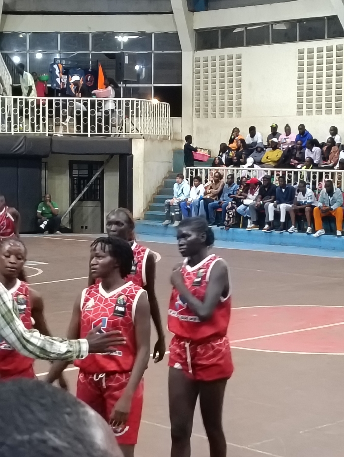 Basketball game between red and orange teams in Nairobi gymnasium