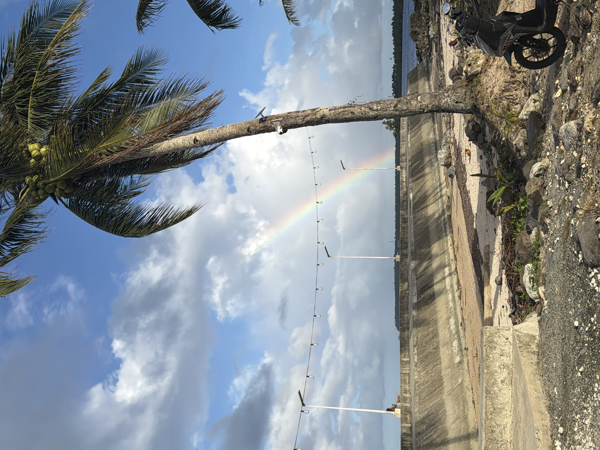 Rainbow appears over General Luna coastline amid cloudy skies