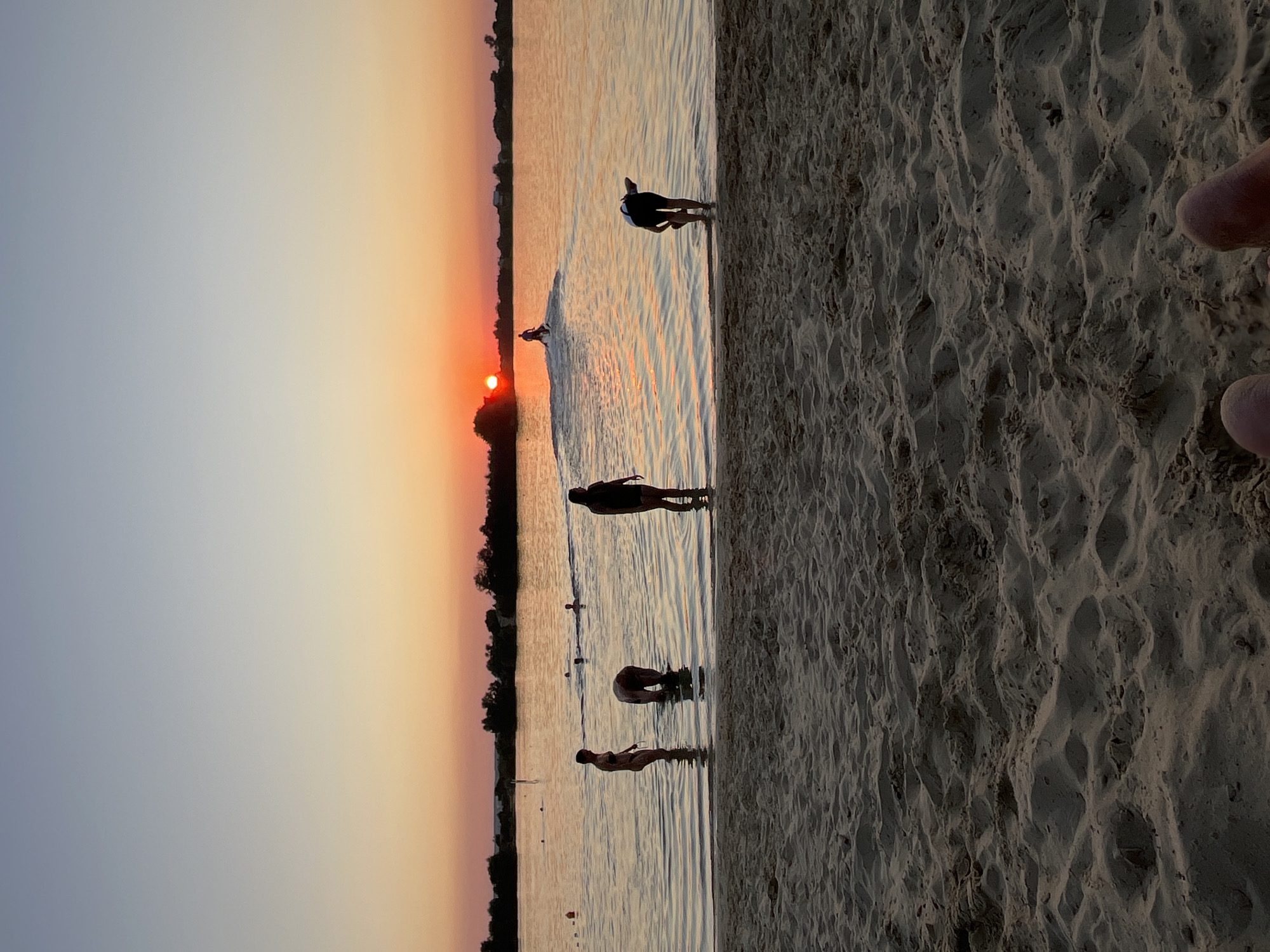 Sunset swim at a sandy Ukrainian lakeshore