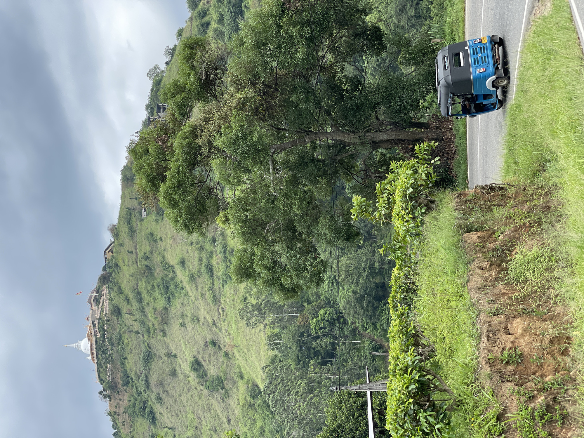 Morning traffic documented near Buddhist stupa in Kumbalwela, Sri Lanka