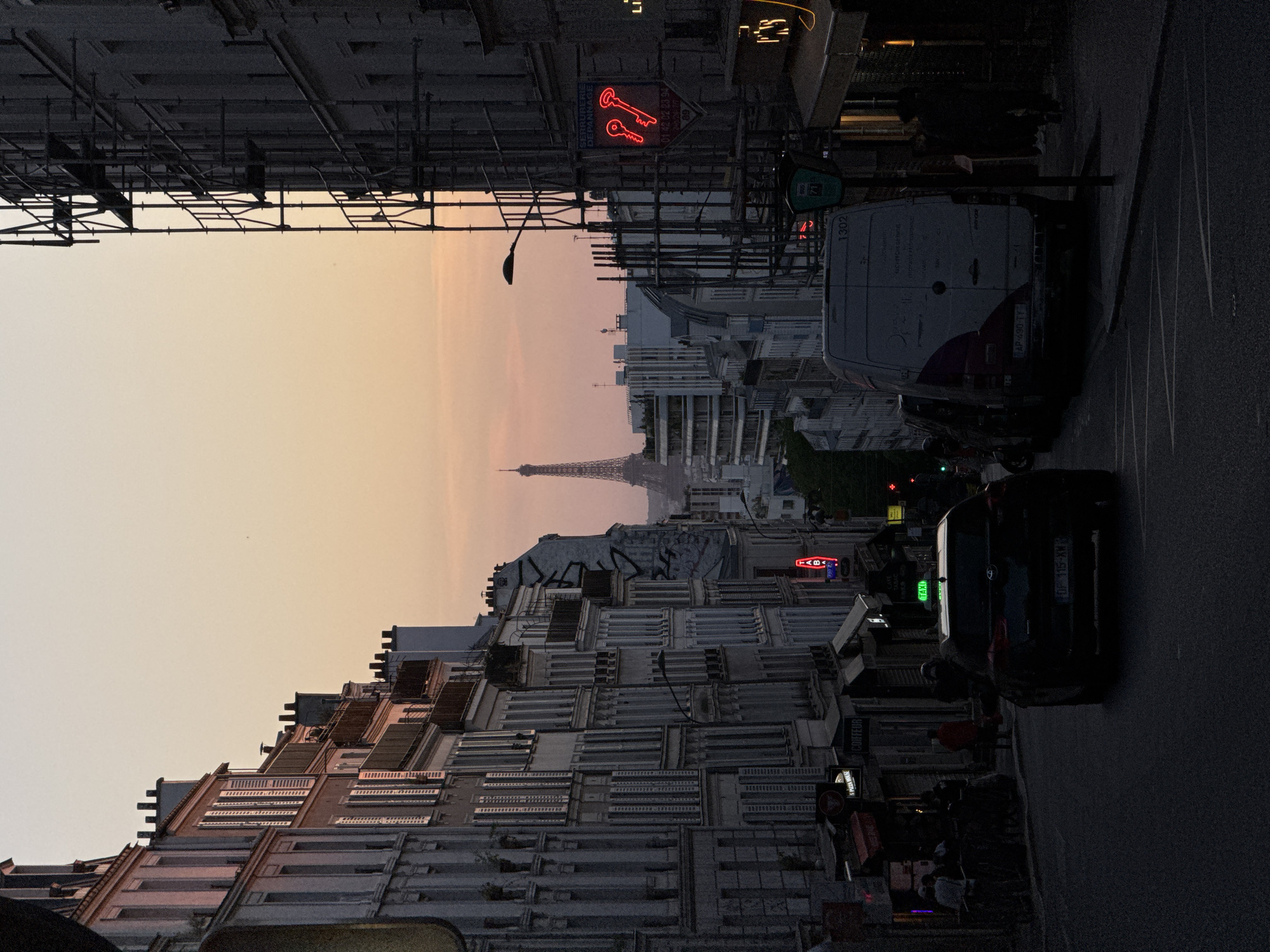 Golden hour illuminates Parisian street with Eiffel Tower view
