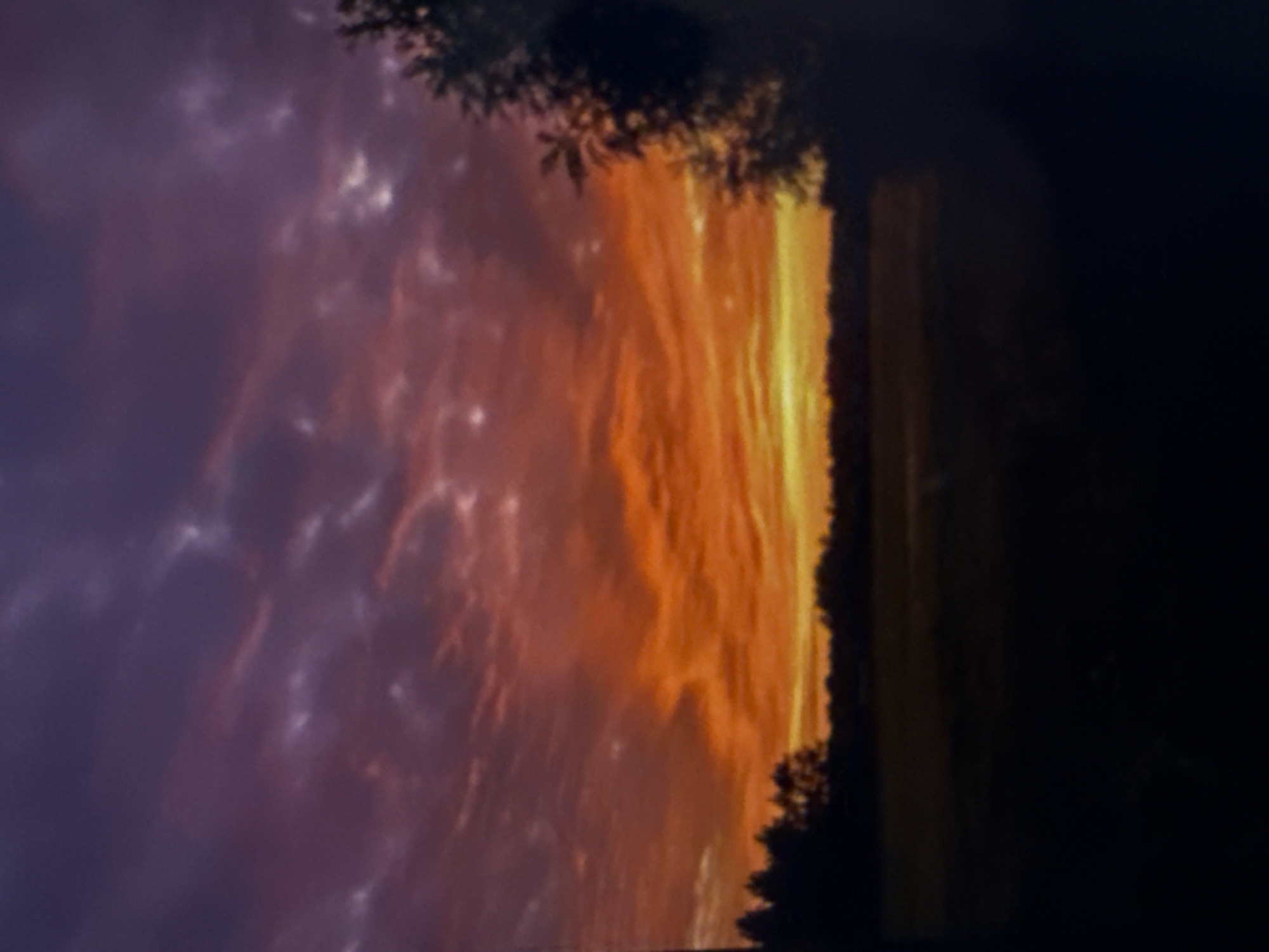 Digital display shows vibrant sunset imagery at unknown location