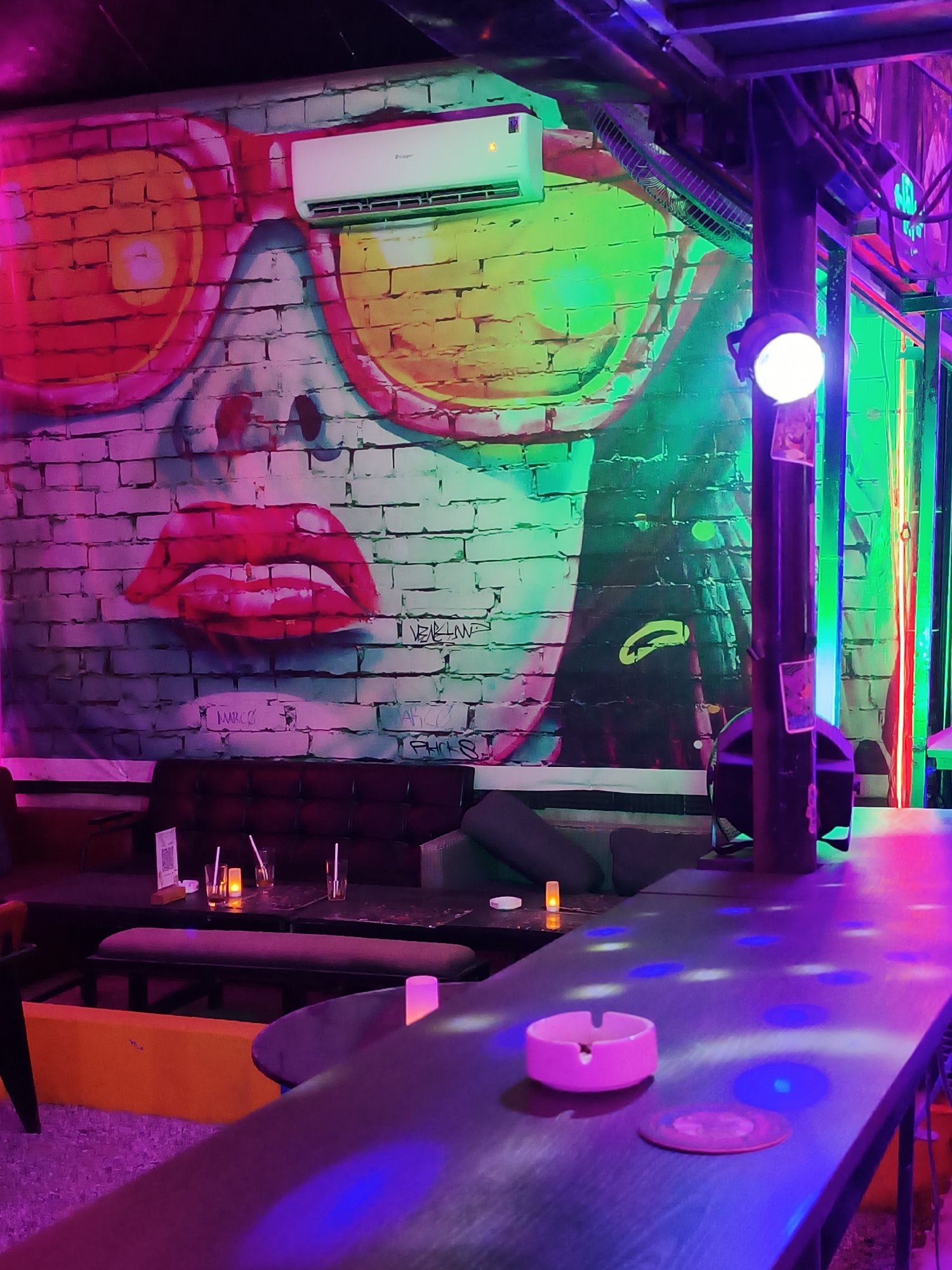Inside a neon-lit bar in Đà Nẵng on a July night