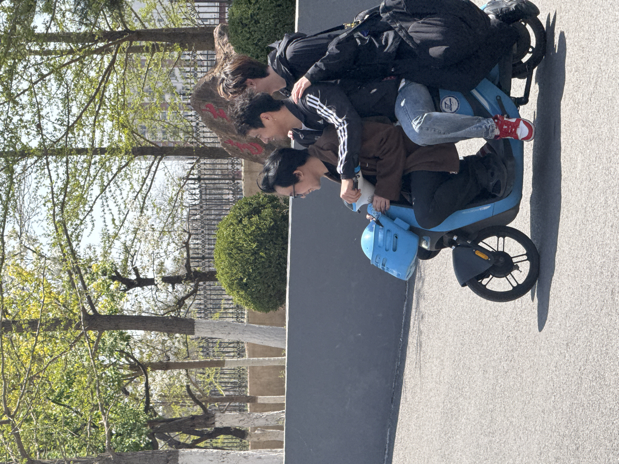Three riders share blue electric scooter in Zhongtun