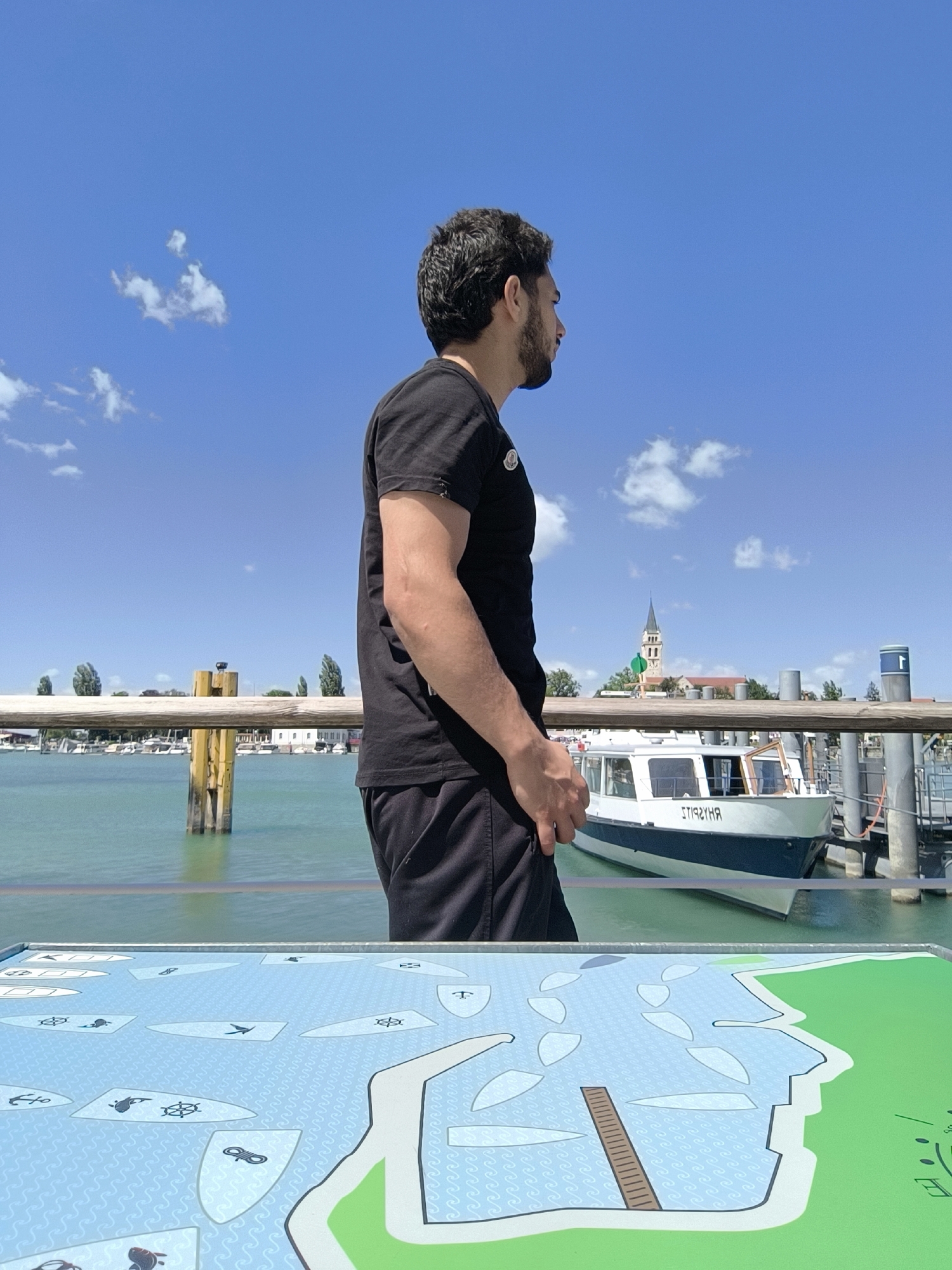 Young men document casual morning at Romanshorn waterfront event
