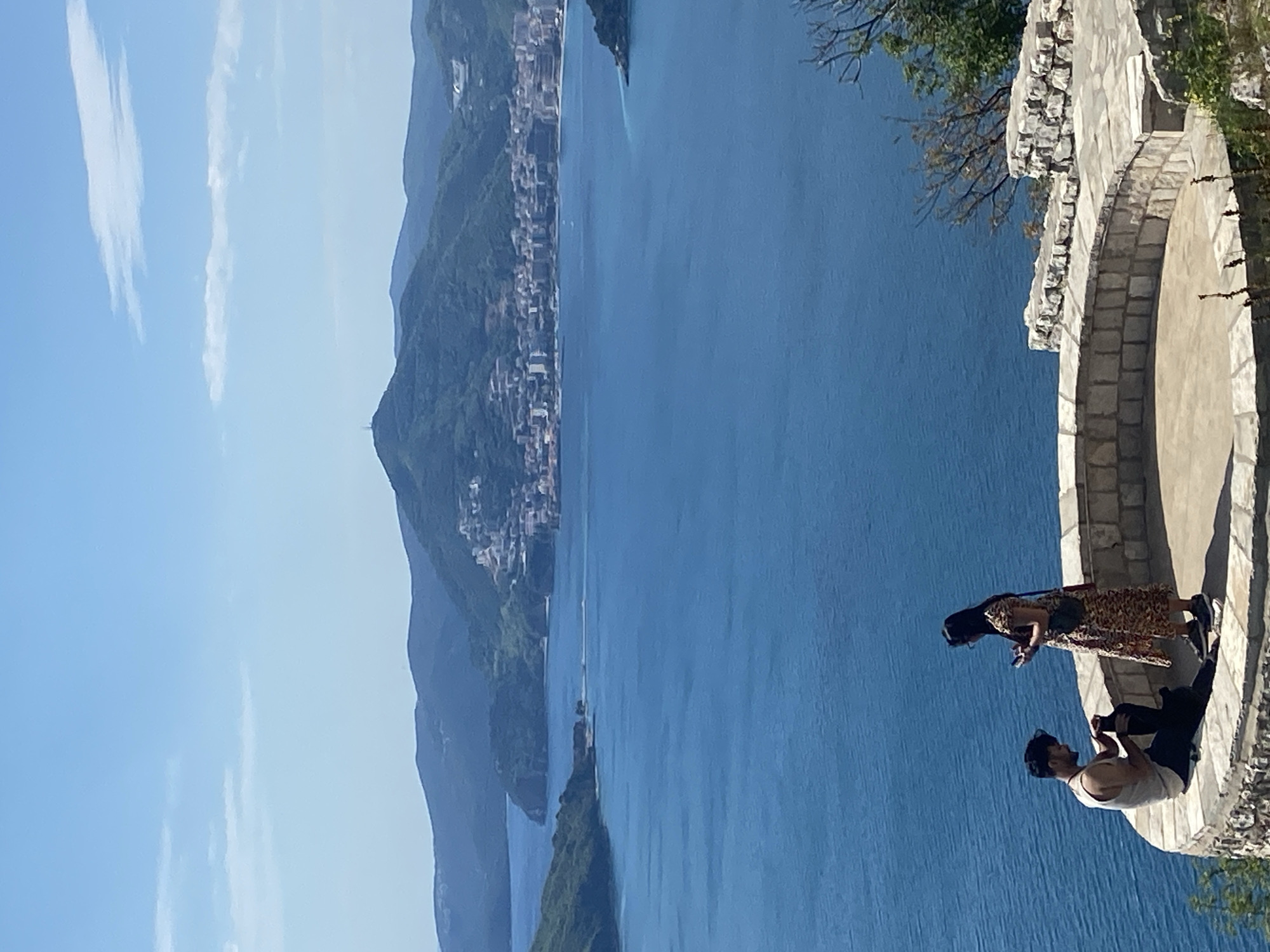 Two visitors enjoy coastal views at Sveti Stefan Montenegro