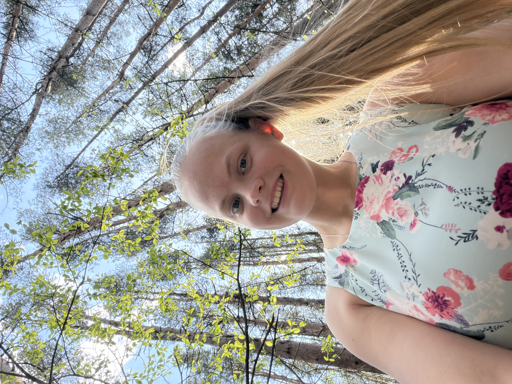 Woman in floral dress photographed walking forest path in Izhevsk
