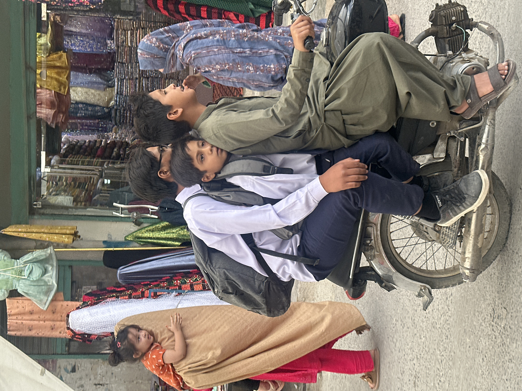 Children gather on street near shops in Quetta