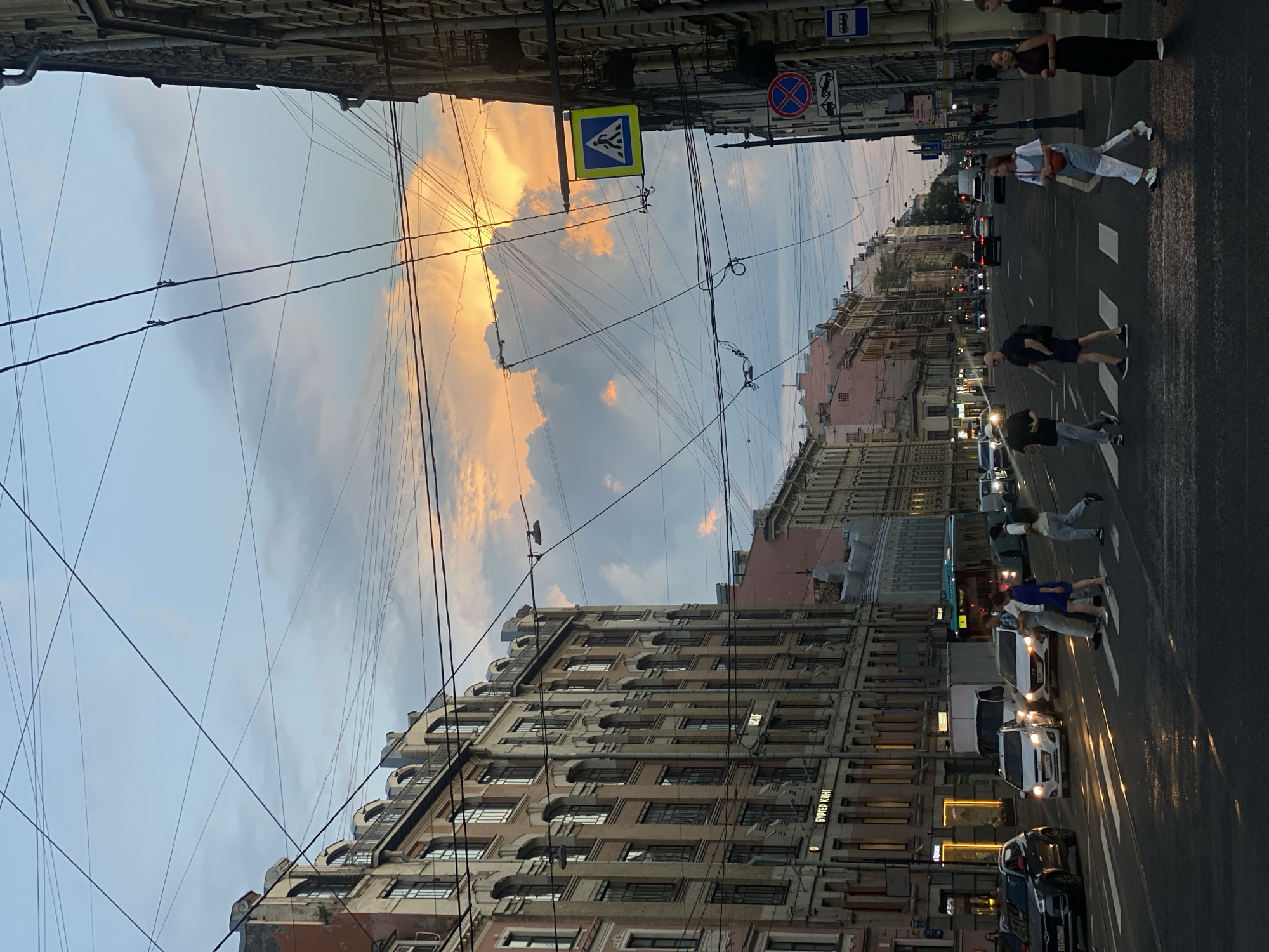 Saint Petersburg street glows under a summer evening sunset.