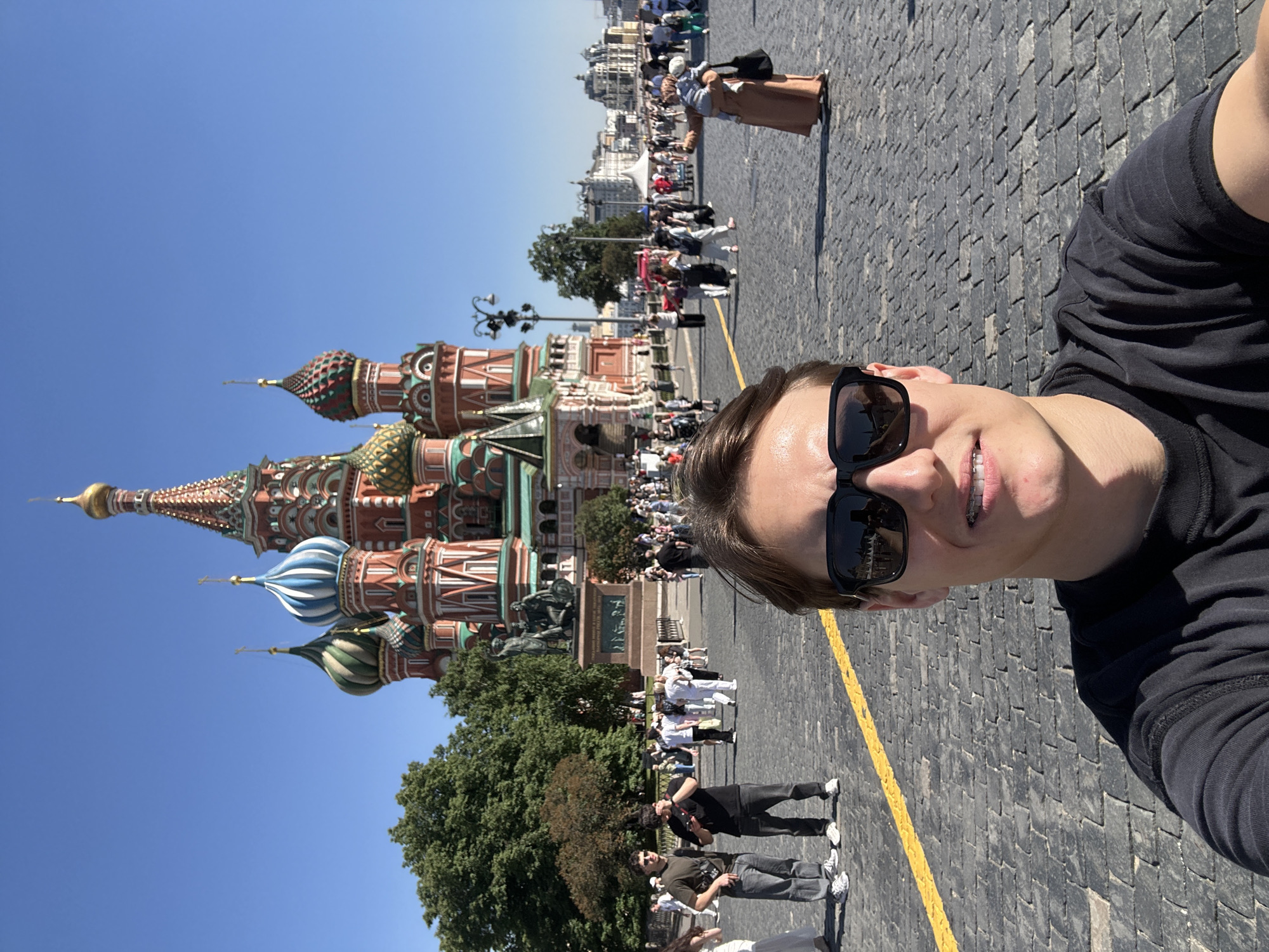 Tourist photographs Red Square landmarks on sunny afternoon