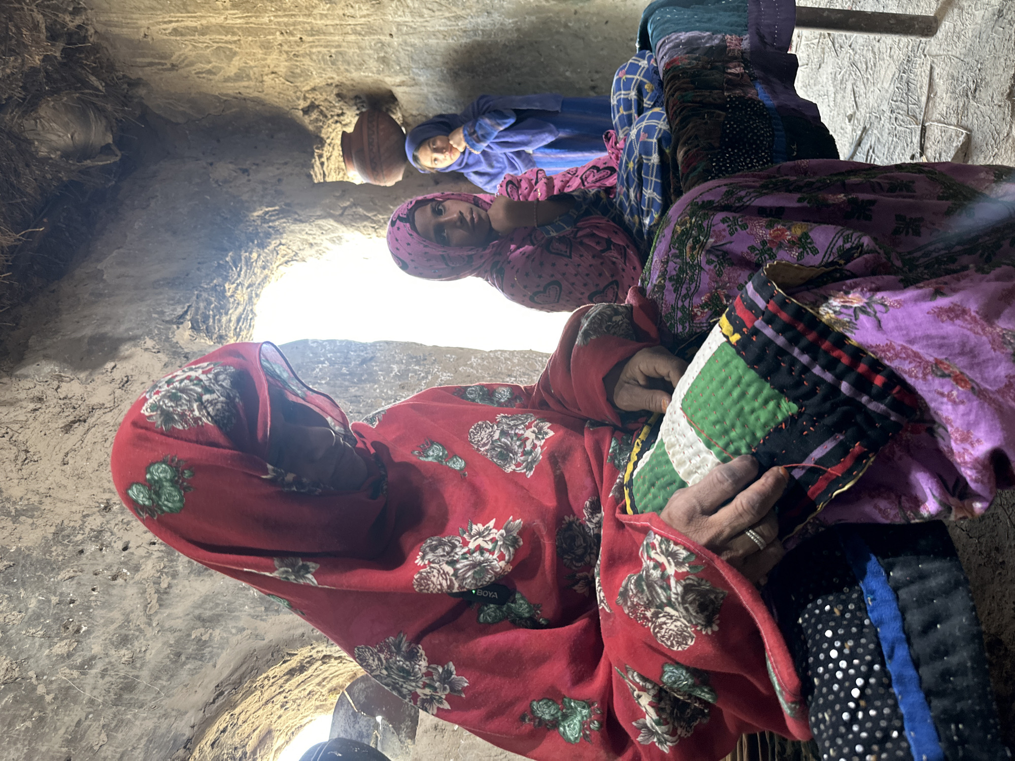 Three women gather in traditional dwelling in Quetta